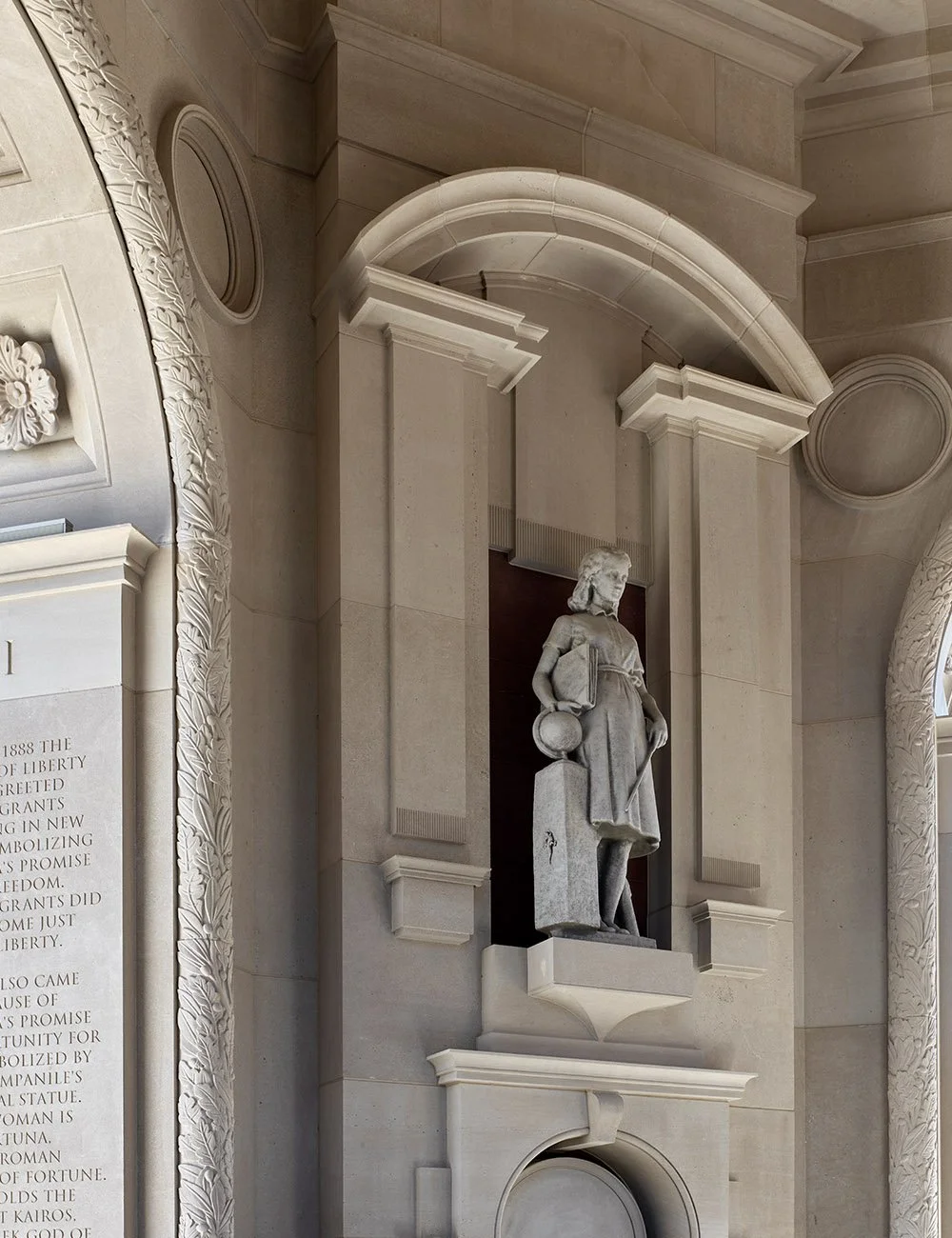 Classical statue set within a stone niche featuring traditional architectural detailing at The Campanile in Dallas.