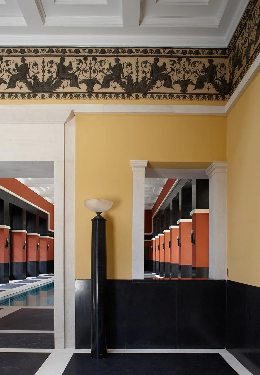 Interior detail of a decorative classical frieze and stone doorway within the Gloucestershire bath house.