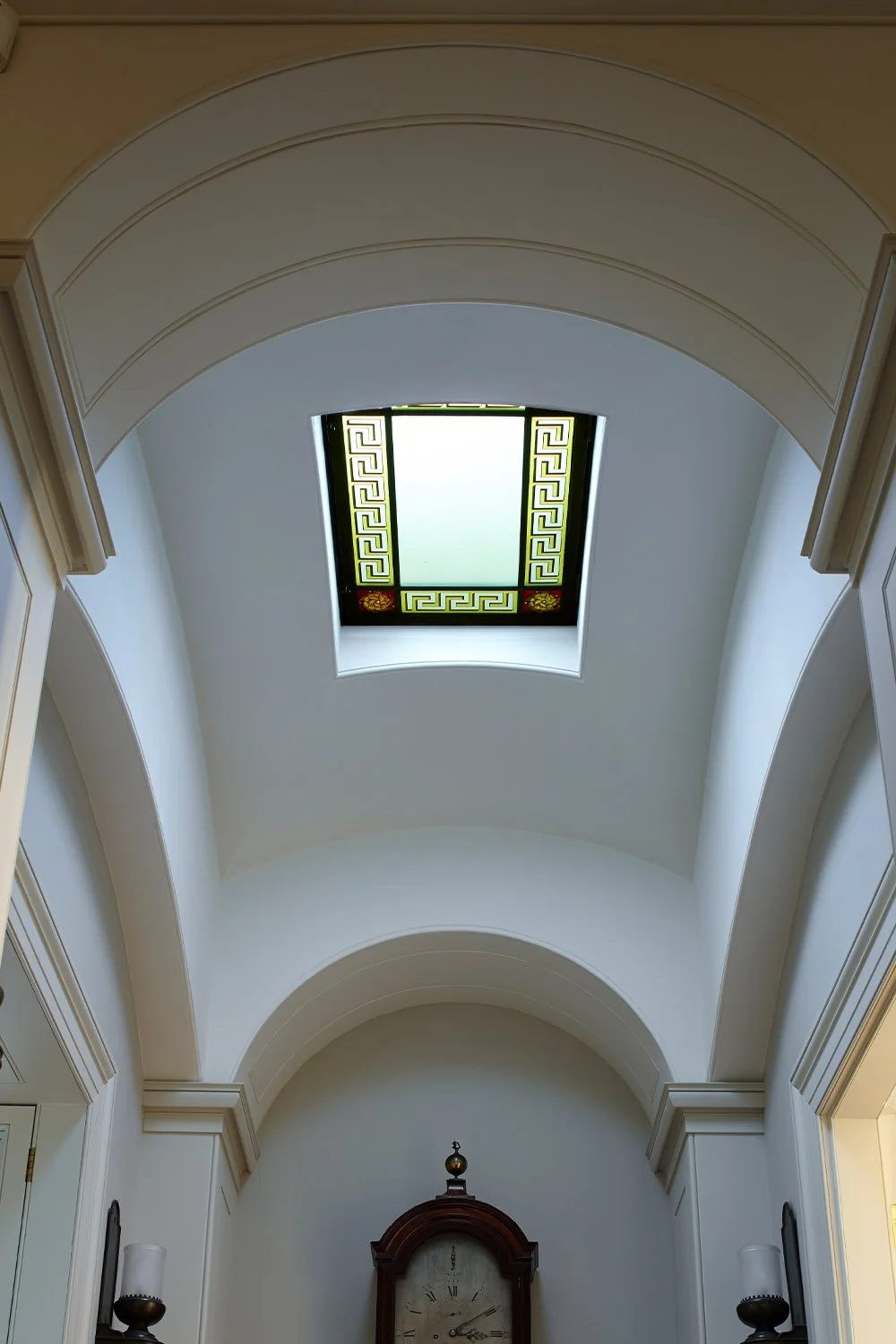 Classically detailed barrel-vaulted ceiling illuminated by a decorative skylight in a historic London apartment.