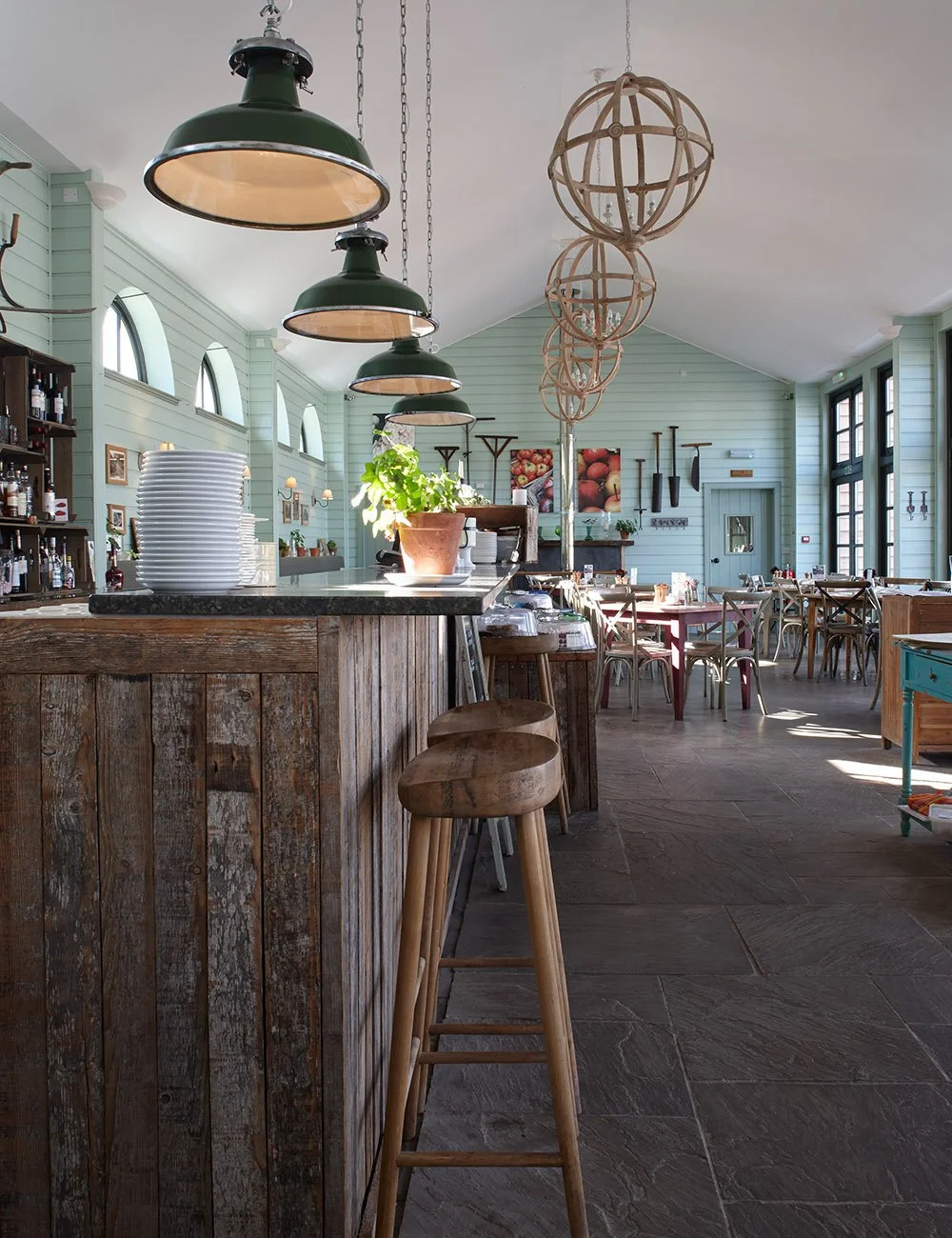 Interior of the café at Gordon Castle Walled Garden with timber counter and vaulted ceiling.