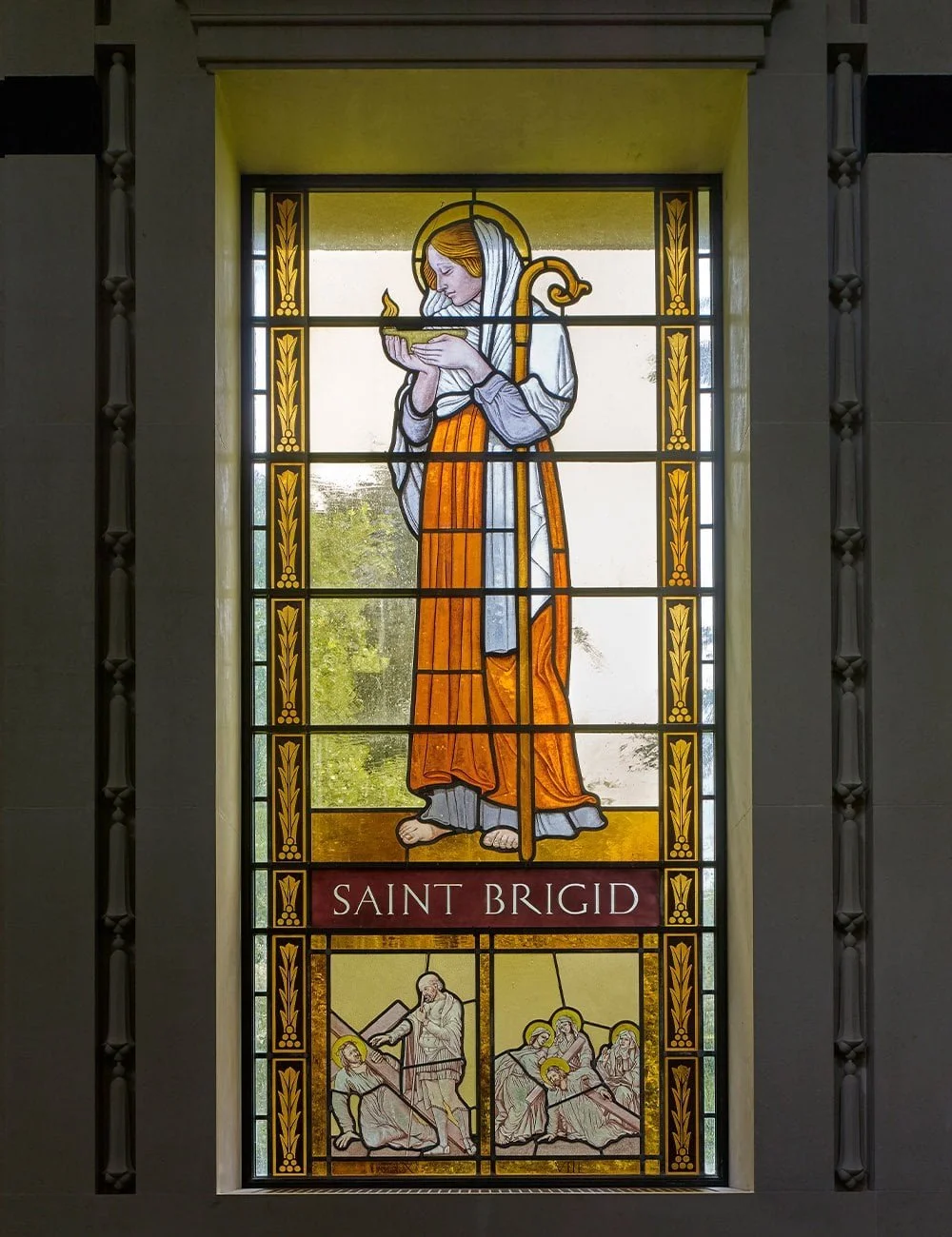Handcrafted stained glass window depicting Saint Brigid within the Chapel of Our Lady at Williamstrip.