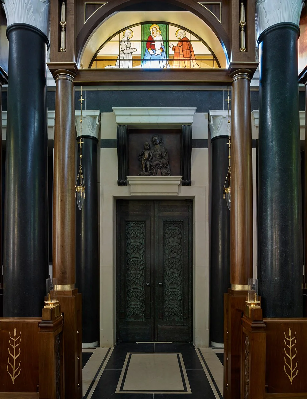 Classical entrance framed by stone columns and stained glass within the Chapel of Our Lady at Williamstrip.