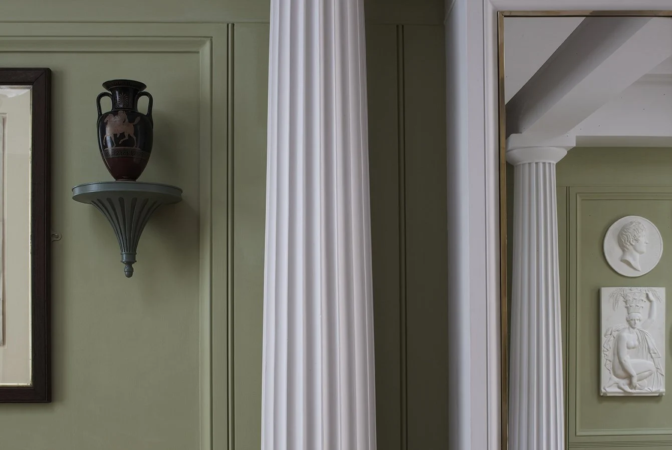 Classical interior niche with decorative urn and fluted column detail at London courtyard house by Craig Hamilton Architects.