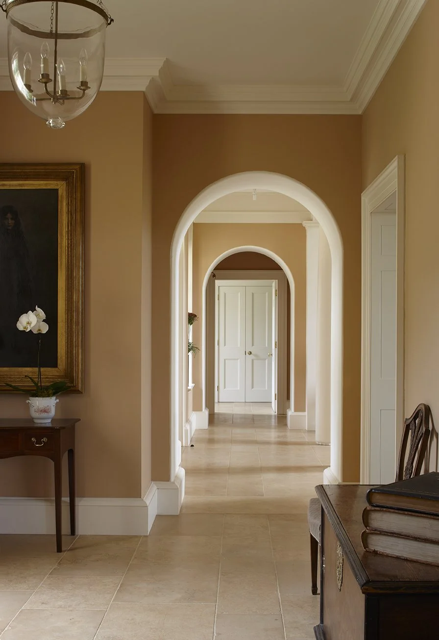 Arched interior corridor in traditional Gloucestershire country house by Craig Hamilton Architects