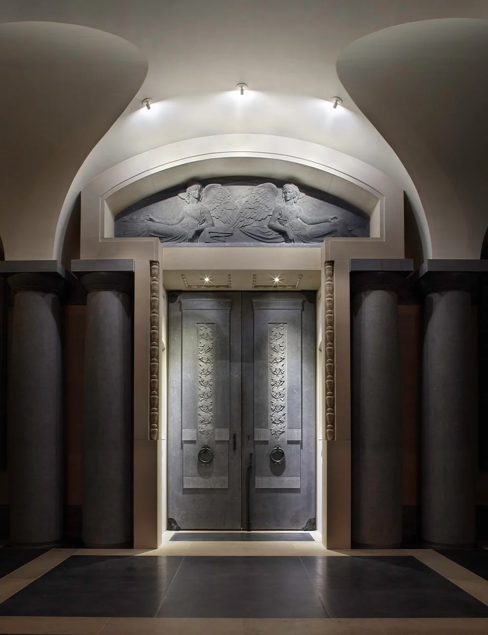 Sacred interior entrance at The Chapel of Christ the Redeemer, Culham featuring classical columns, vaulted ceilings and carved stone relief.