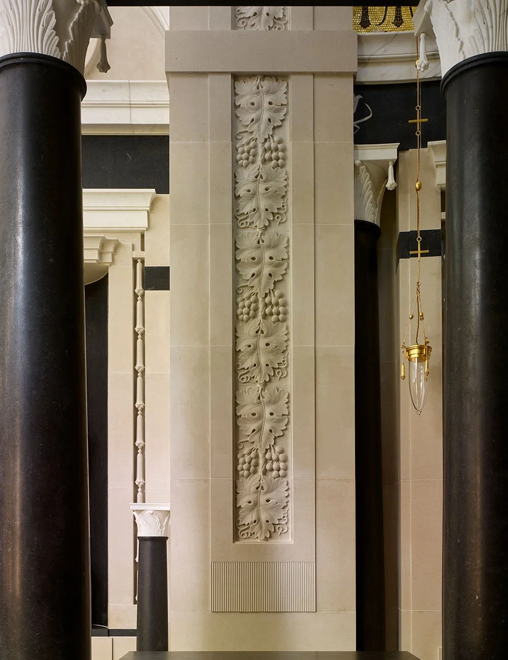 Hand-carved stone relief panel integrated into the classical interior architecture of the Williamstrip chapel.