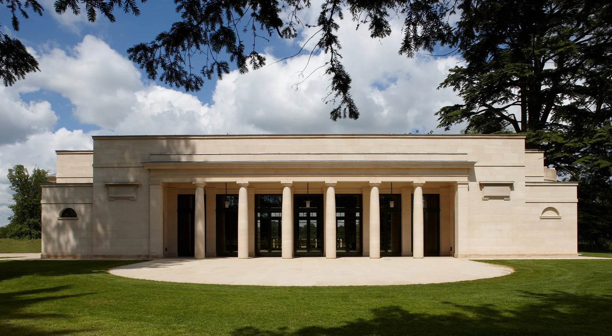 Garden elevation of a new bath house in Gloucestershire featuring a limestone colonnade and symmetrical classical design.