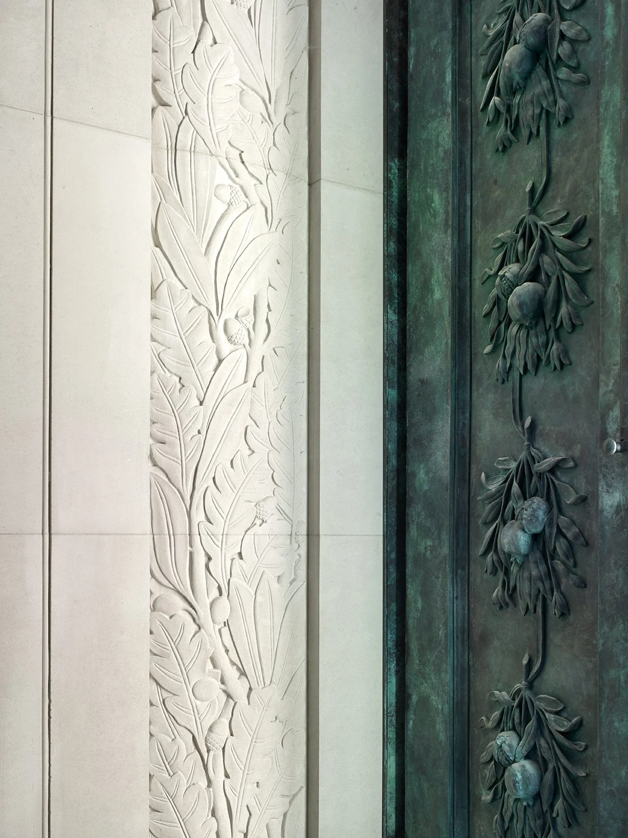 Detail of bronze mausoleum doors with sculpted botanical ornament and finely carved stone surrounds.