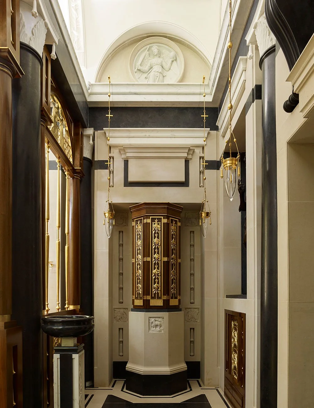 Interior architectural detail of the Chapel of Our Lady at Williamstrip showing classical stonework, joinery and sacred ornament.