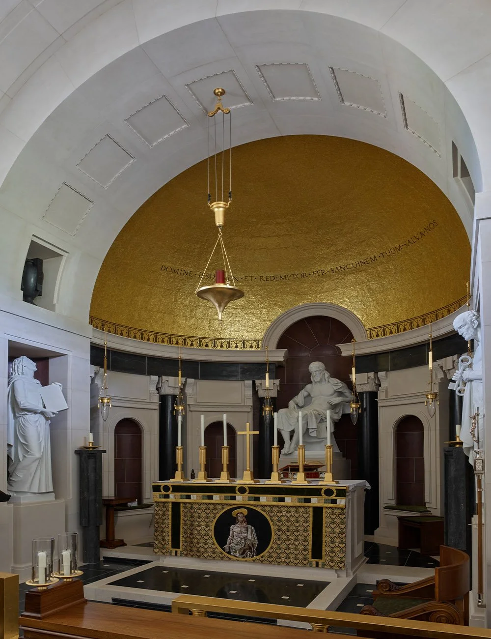 Interior altar view of The Chapel of Christ the Redeemer at Culham with gilded apse and classical sacred detailing.