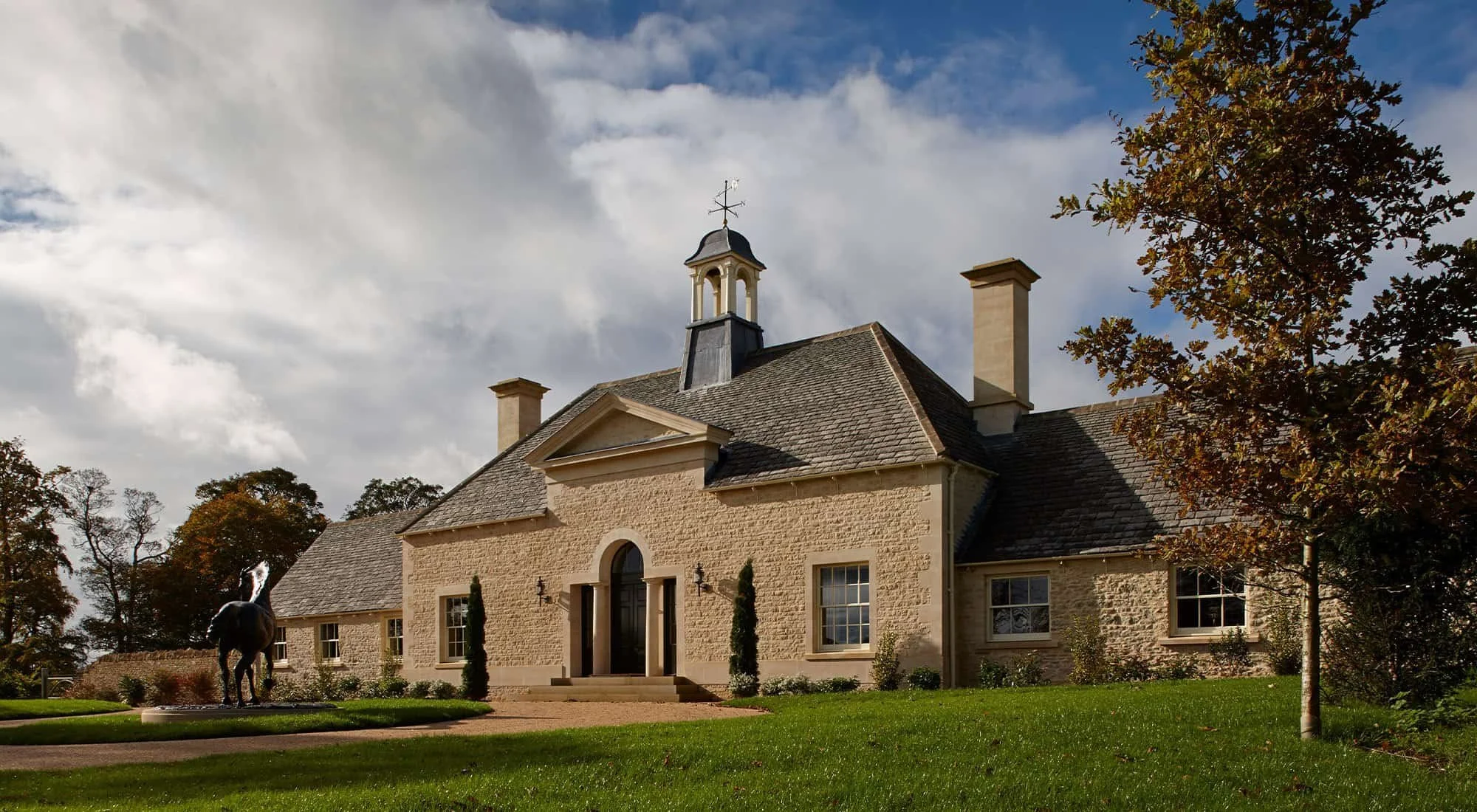 Front elevation of the Shooting Lodge in Gloucestershire, a classical limestone country house designed by Craig Hamilton Architects.