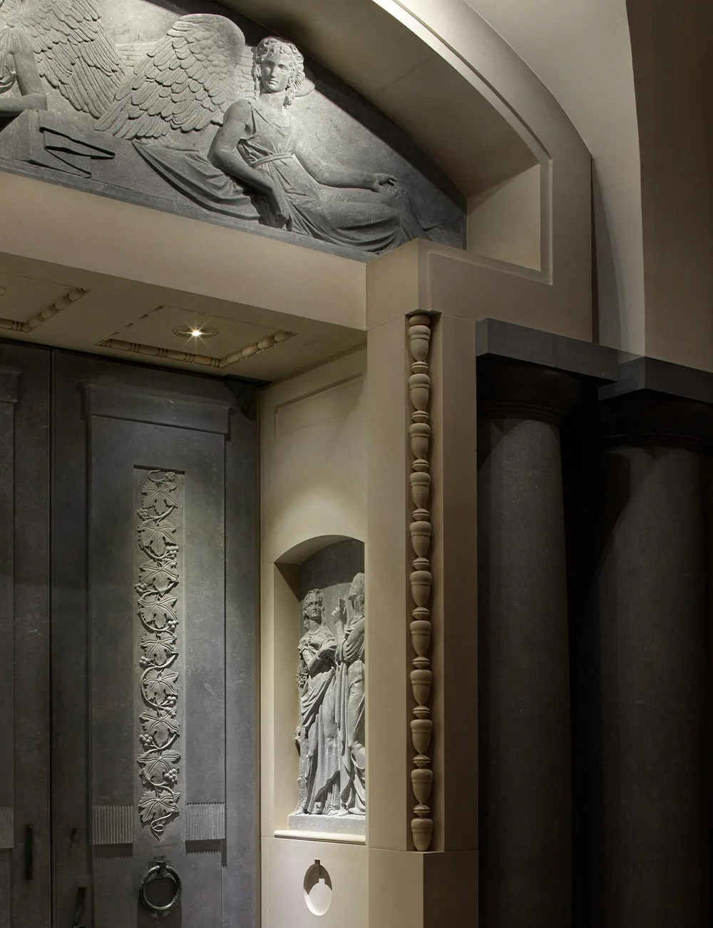 Sculptural sacred interior detail with carved reliefs and classical columns at The Chapel of Christ the Redeemer, Culham.