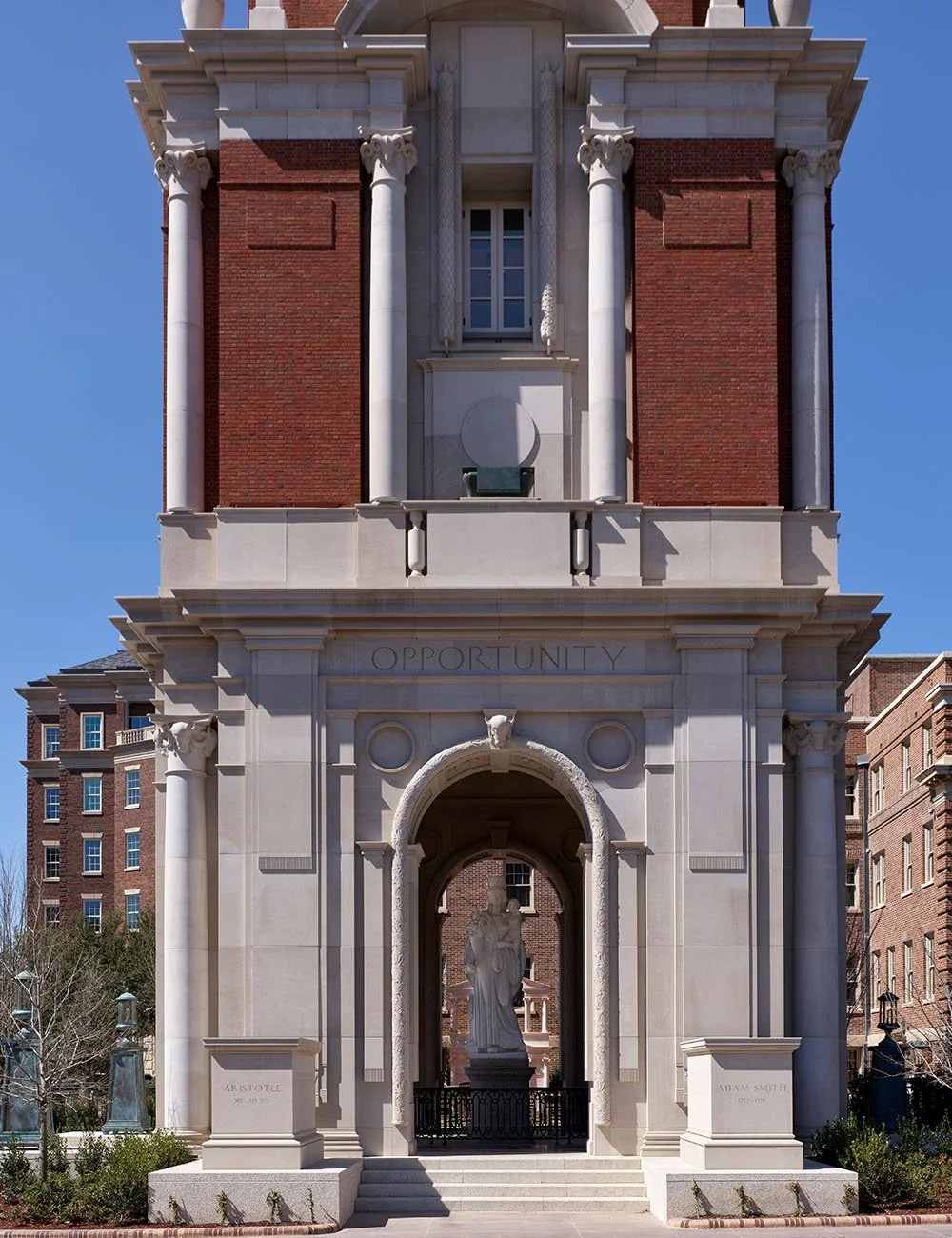 The base of The Campanile clock tower featuring a monumental classical archway and stone detailing.