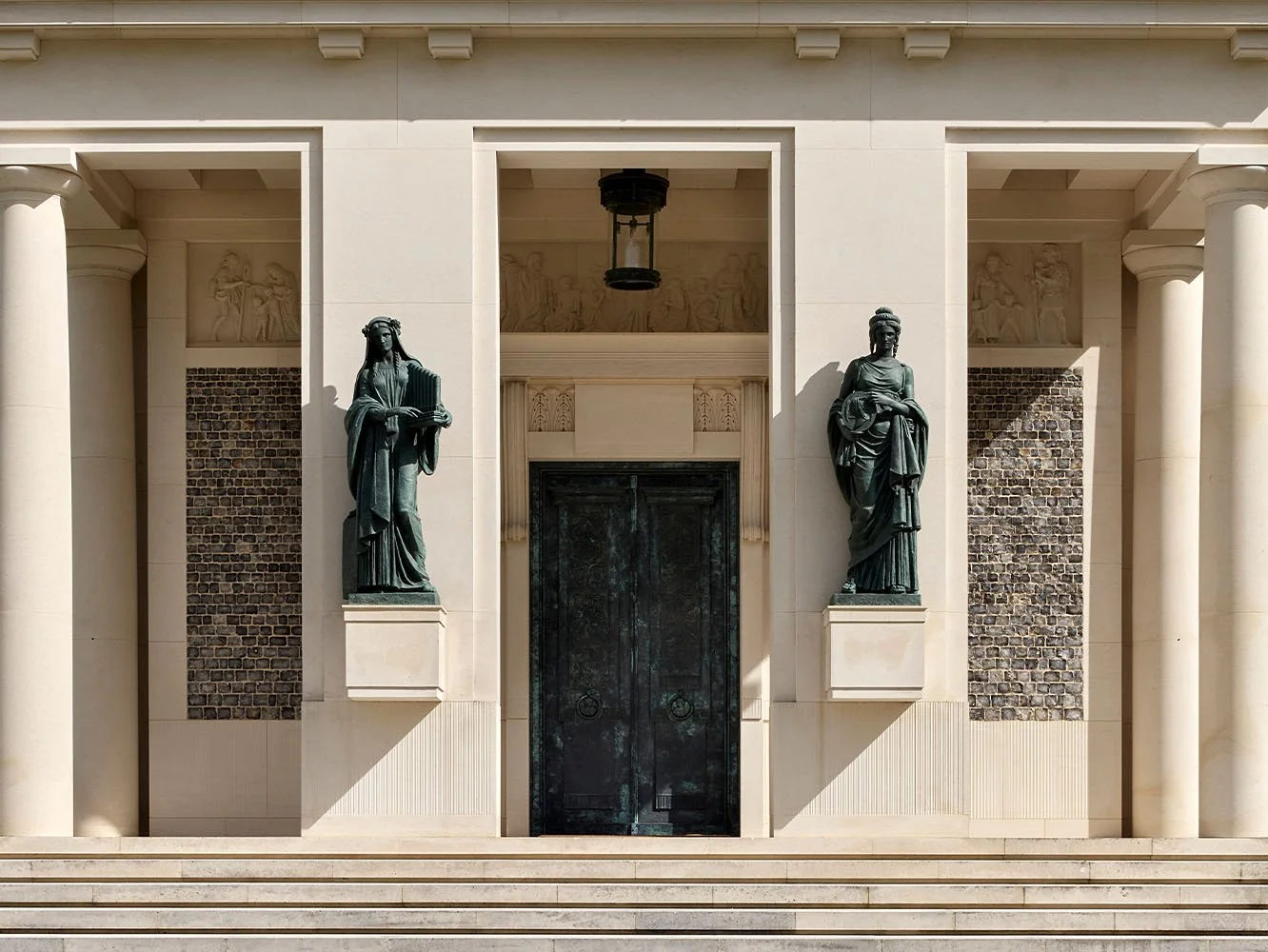 Classical entrance portico with bronze statues at The Chapel of Christ the Redeemer, Culham.
