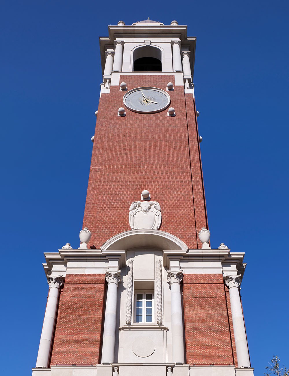 View of The Campanile tower base highlighting classical proportions, brickwork and stone ornamentation.