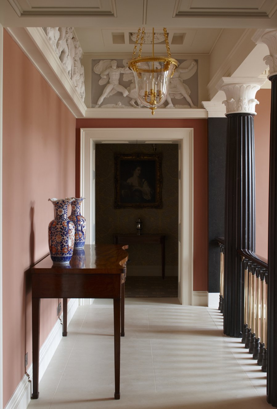 Classical interior corridor with sculptural frieze and columns in Gloucestershire country house by Craig Hamilton Architect