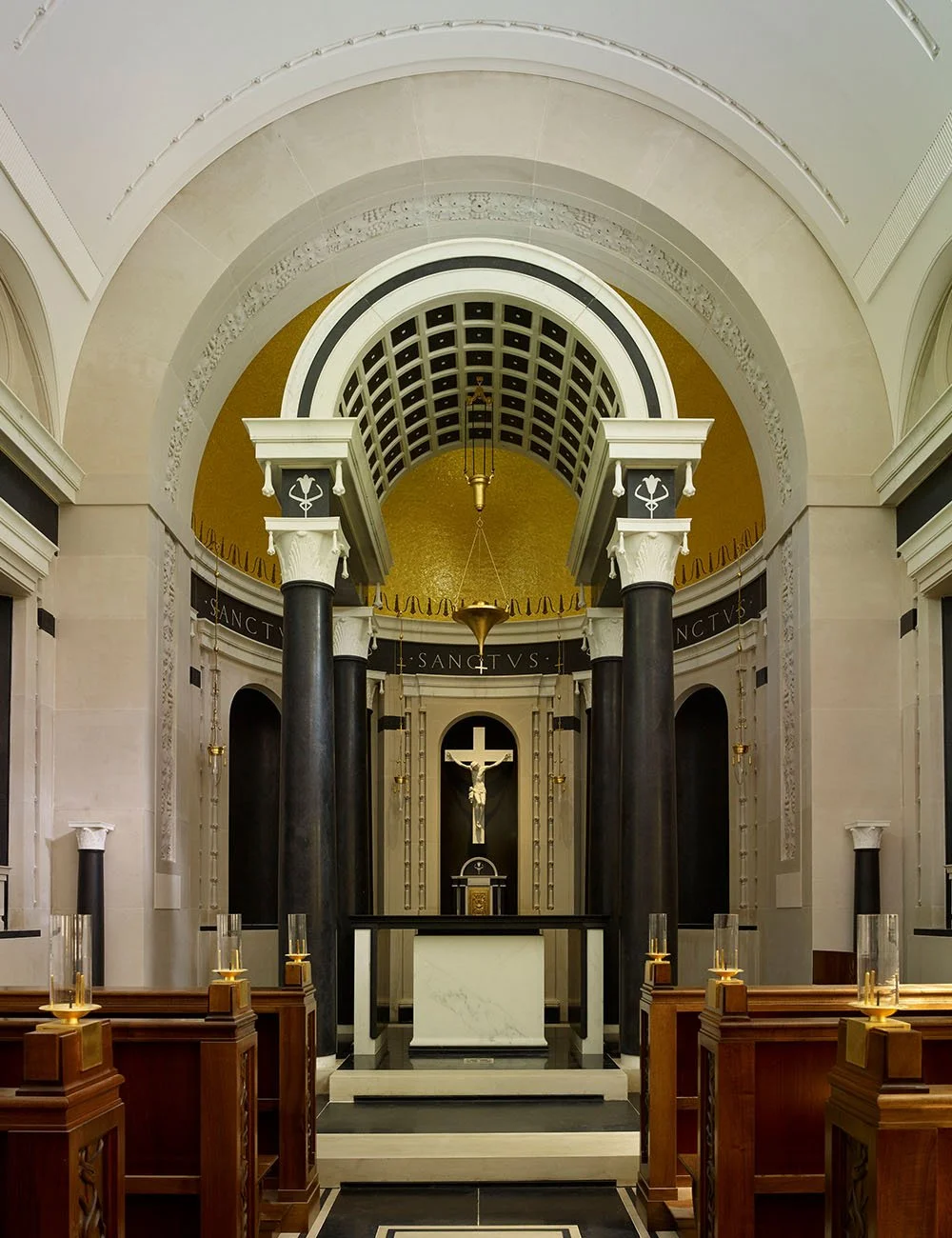 View towards the sanctuary and altar within the Chapel of Our Lady at Williamstrip, framed by classical columns and vaulted ceilings.