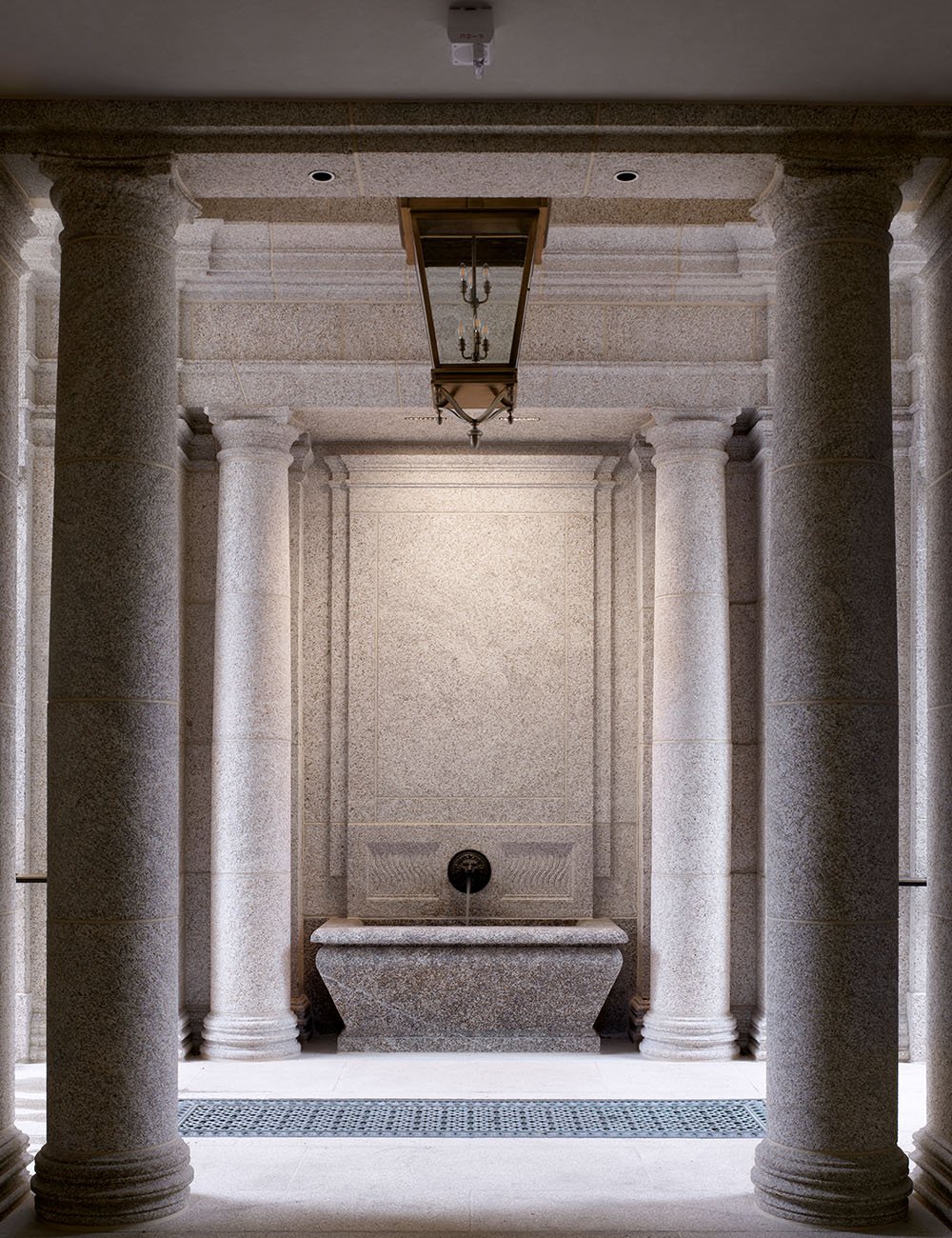 Interior hall with stone columns, vaulted ceiling and classical architectural proportions at The Campanile, Dallas.