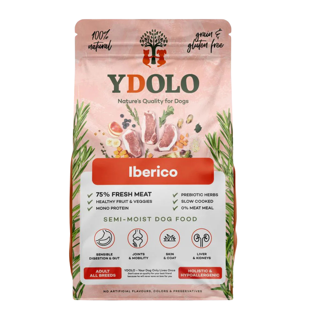 Pink dog food bag labeled 'Y DOLO' with a tree and two dogs logo, stating 'Nature's Quality for Dogs.' Features 'Iberico' flavor, highlights 75% fresh meat, healthy fruits and vegetables, mono protein, prebiotic herbs, slow cooked, zero meat meal. Contains semi-moist dog food for adult all breeds, promoting digestion, joints, skin, liver, and kidneys health. No artificial flavors, colors, or preservatives.
