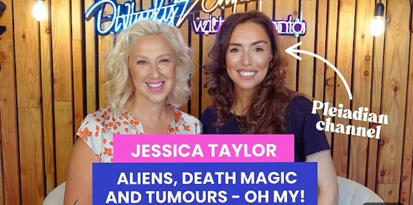 A woman with long hair and closed eyes, wearing a blue robe, is standing against a dreamy, ethereal background with soft clouds and light flares.