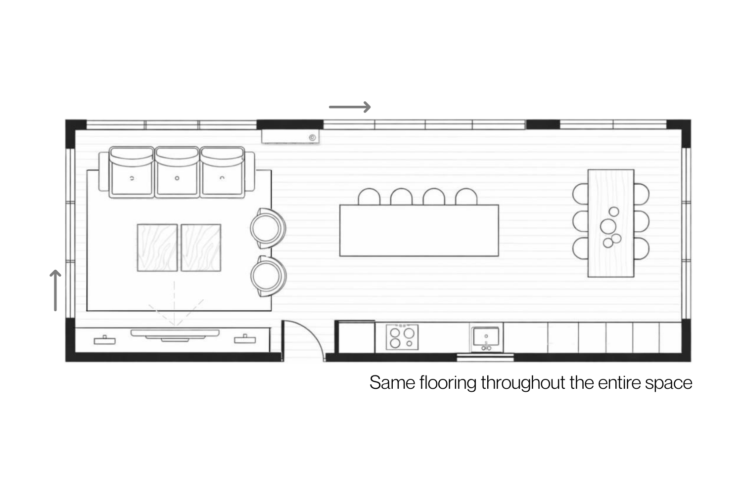 Open-plan kitchen dining living layout showing consistent flooring throughout the entire space.