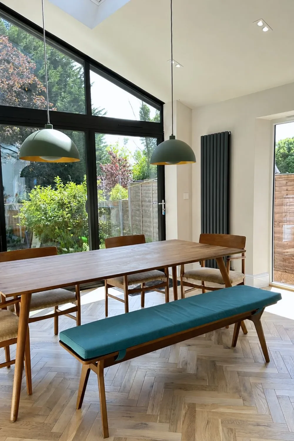 Dining zone with bench seating and forest green dome pendants in a Birmingham open-plan kitchen-diner