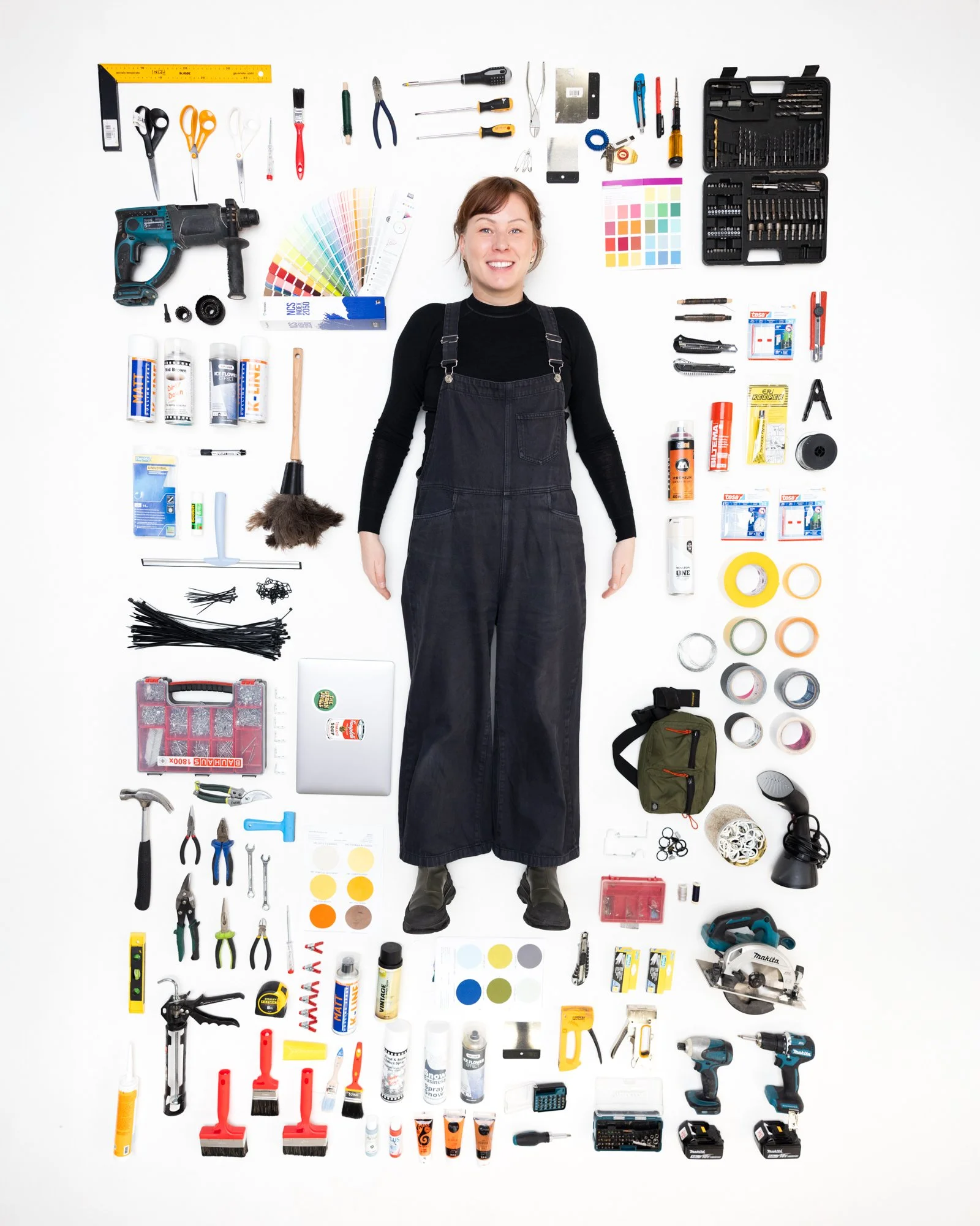 A woman standing on a white background surrounded by various tools and supplies arranged in a grid.