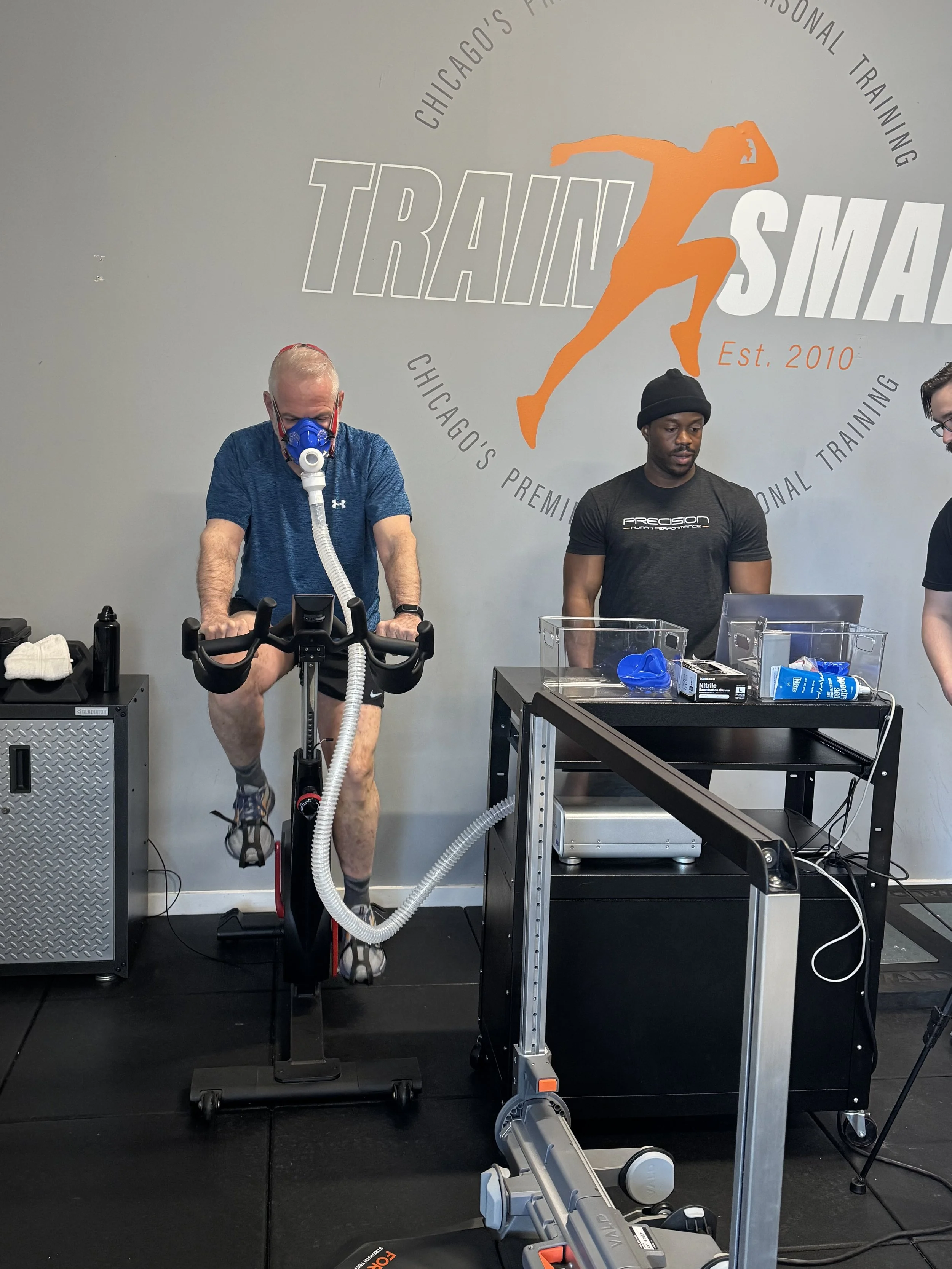 Man taking VO2max test on bike with exercise physiologist