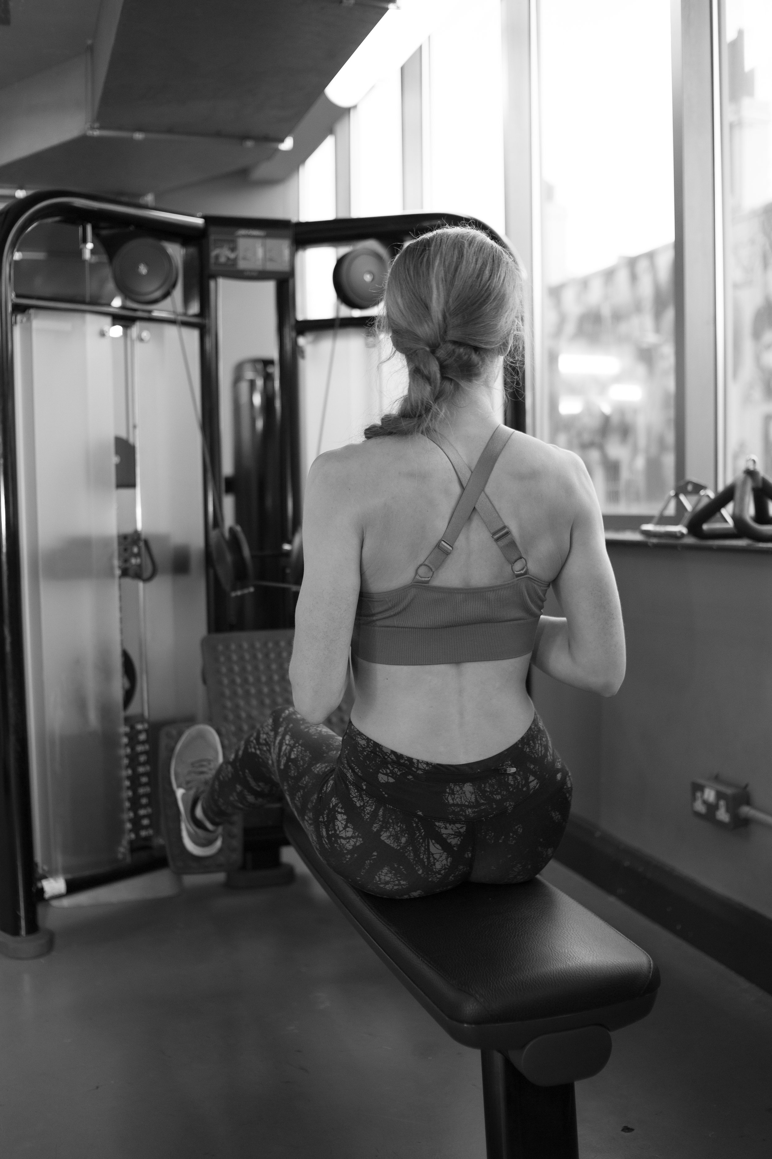 Laura, a personal trainer in Brighton demonstrating how to use the gym equipment.