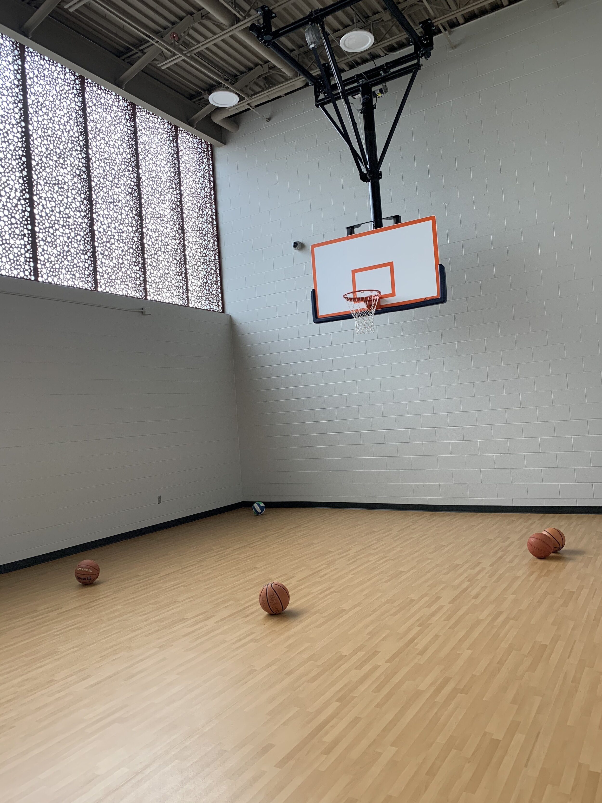 Indoor recreation area at the Jasper County Juvenile Detention Center with basketball hoop and activity space