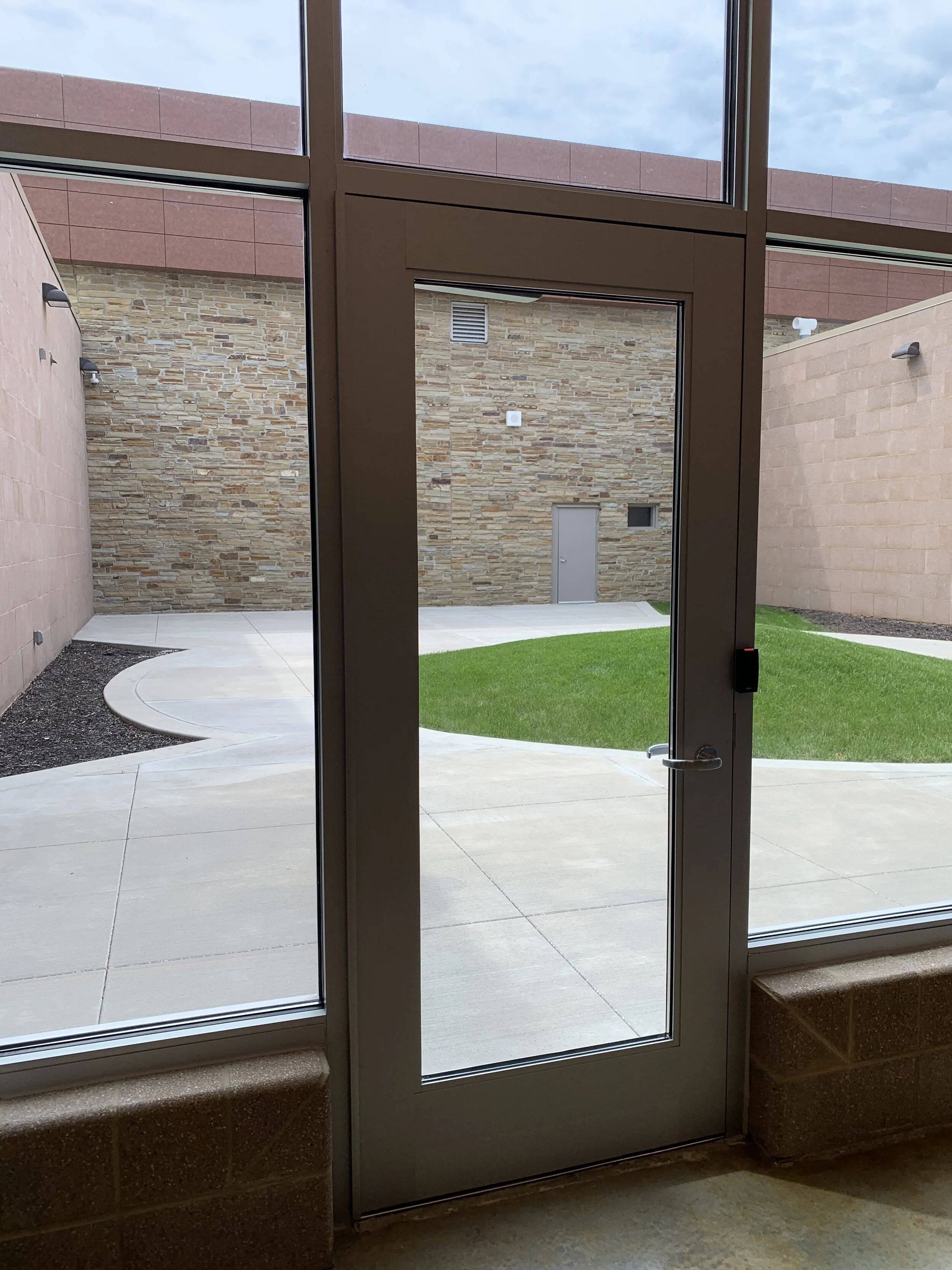 Outdoor recreation courtyard at the Jasper County Juvenile Detention Center viewed from inside the facility