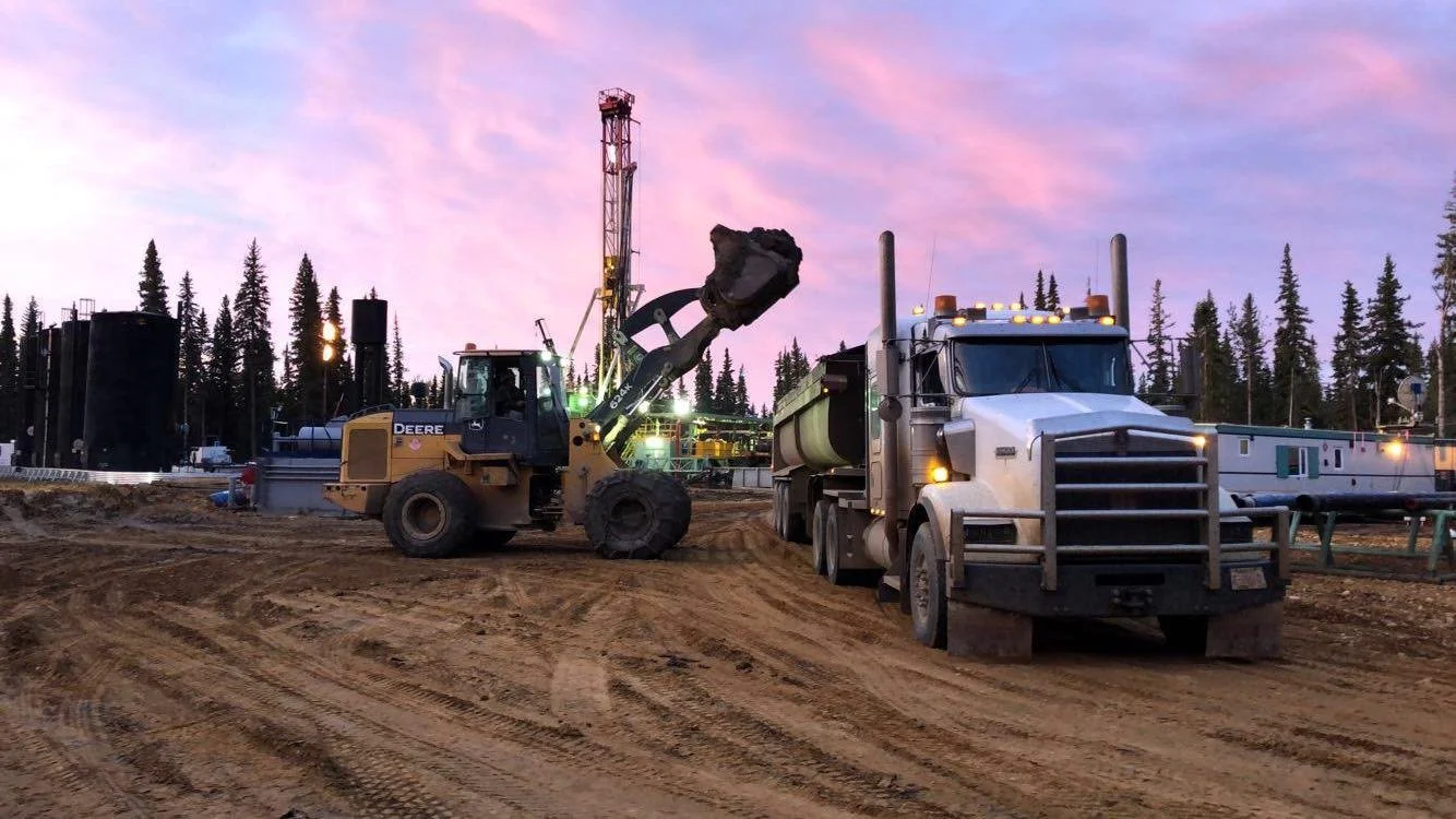 Drill cuttings being loaded onto a compliant truck at an oil rig site