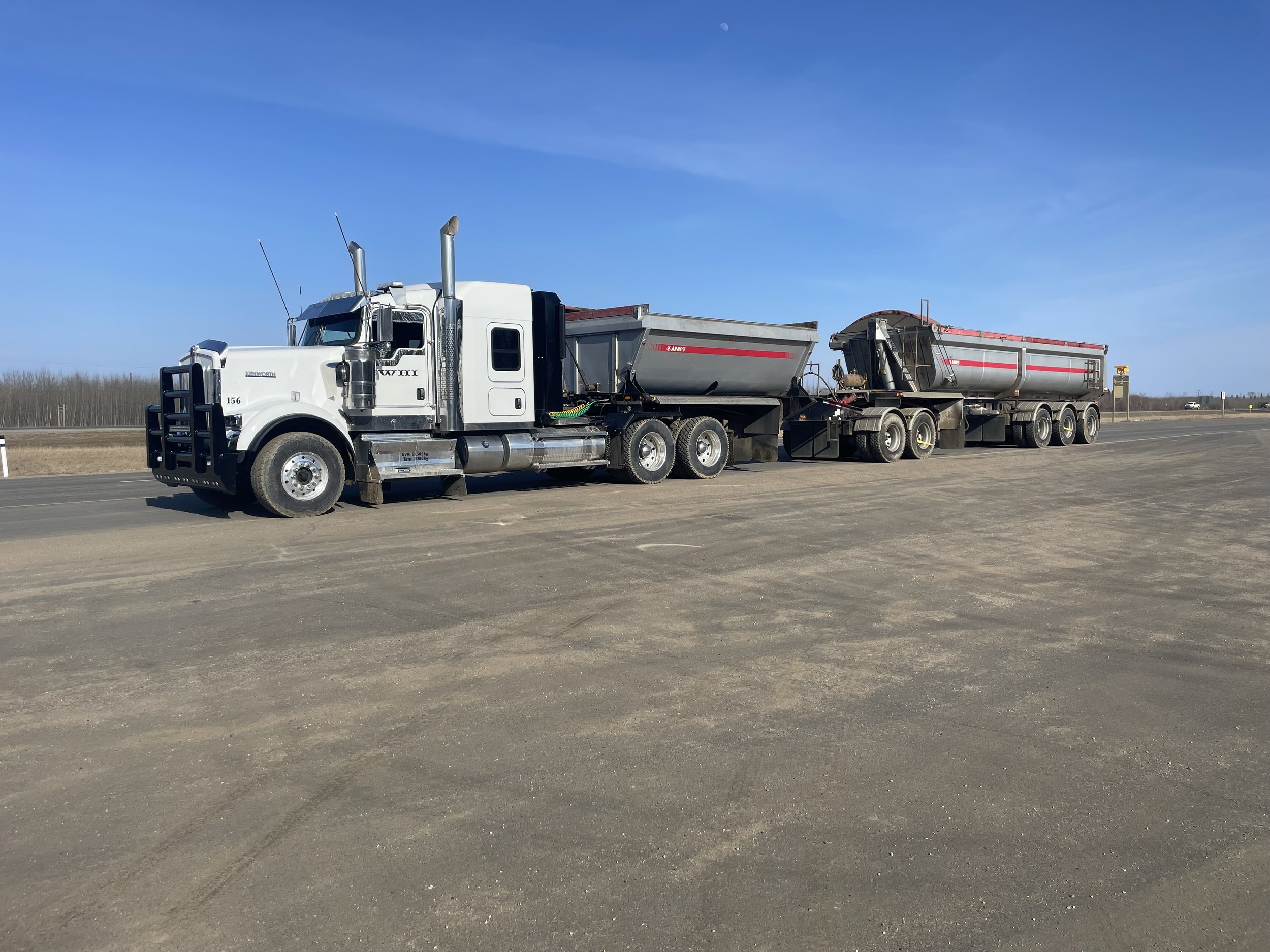 Tri Drive End Dump Truck hauling aggregates for construction projects