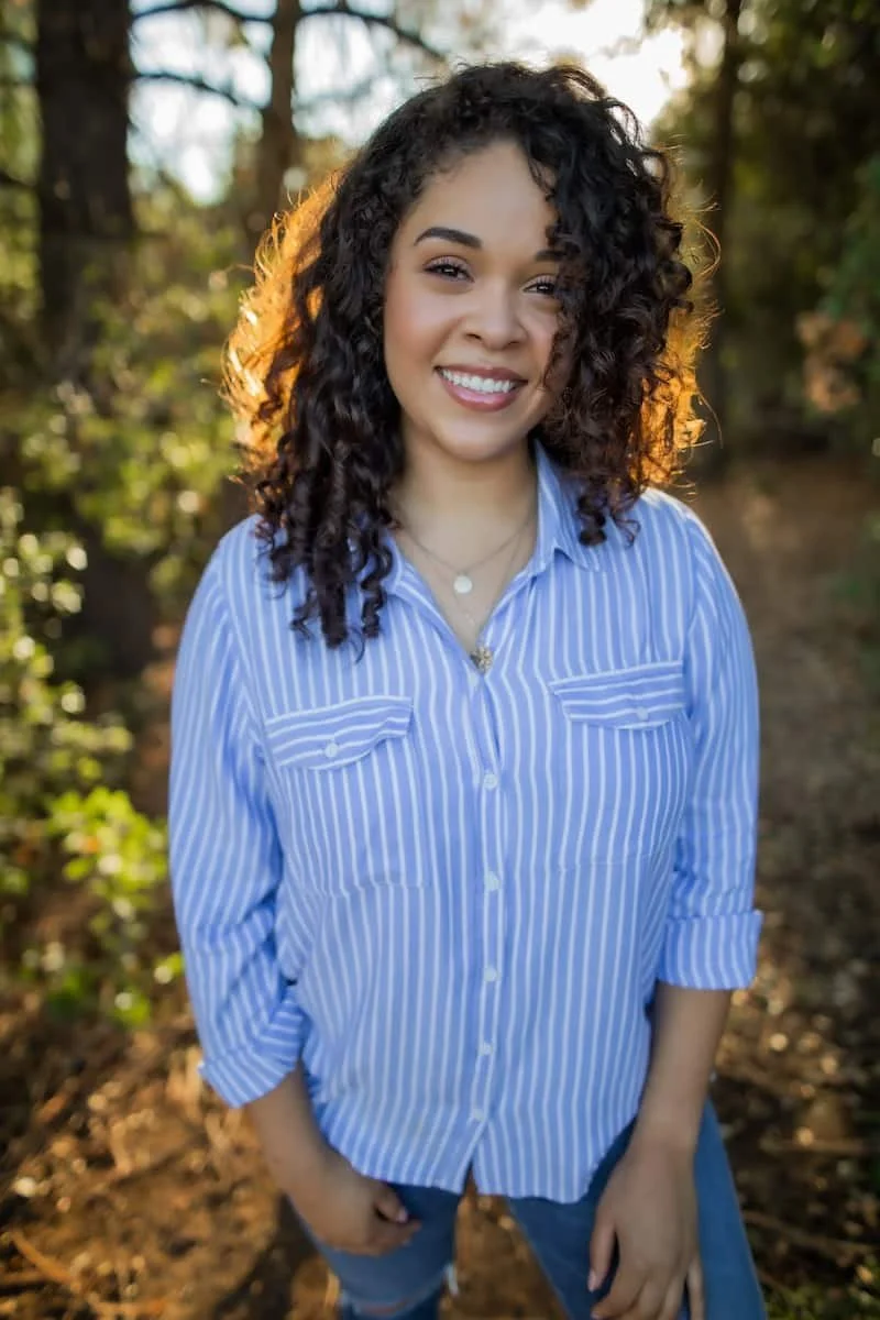 Jasmine Wilson, LCSW, smiling outdoors in a professional portrait for Adaptive Resolutions Counseling.