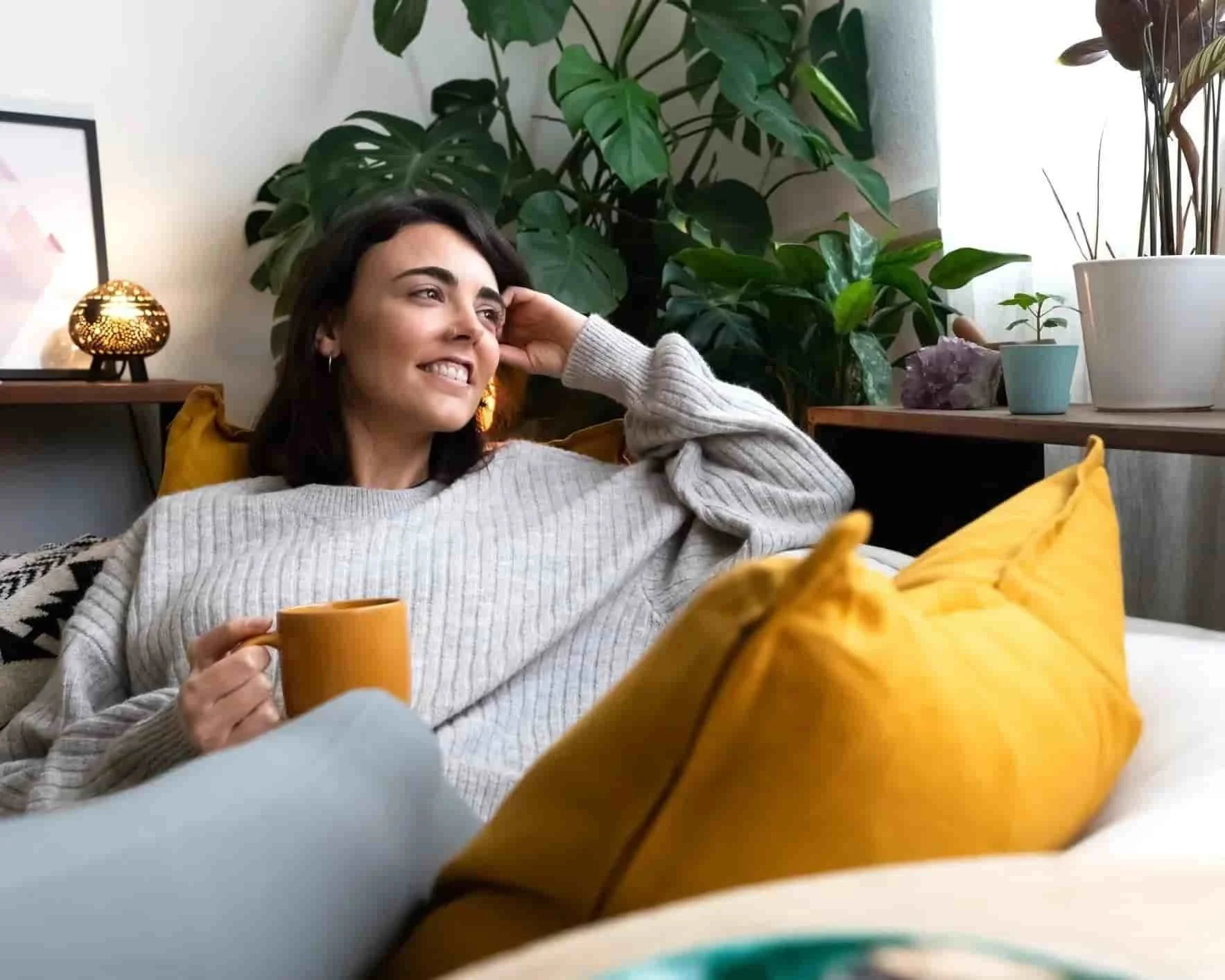 Woman relaxing on a couch in a comfortable home setting