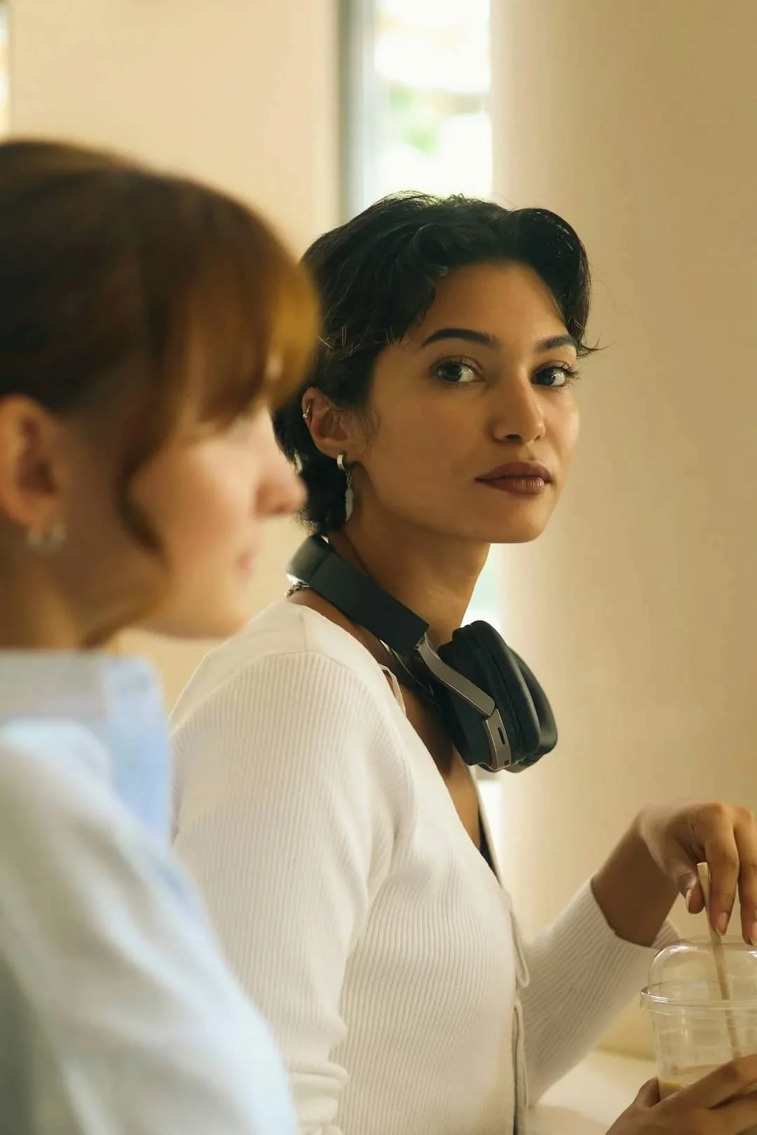 Person watching another person during a conversation, reflecting the relational awareness often connected to people-pleasing and anxiety.