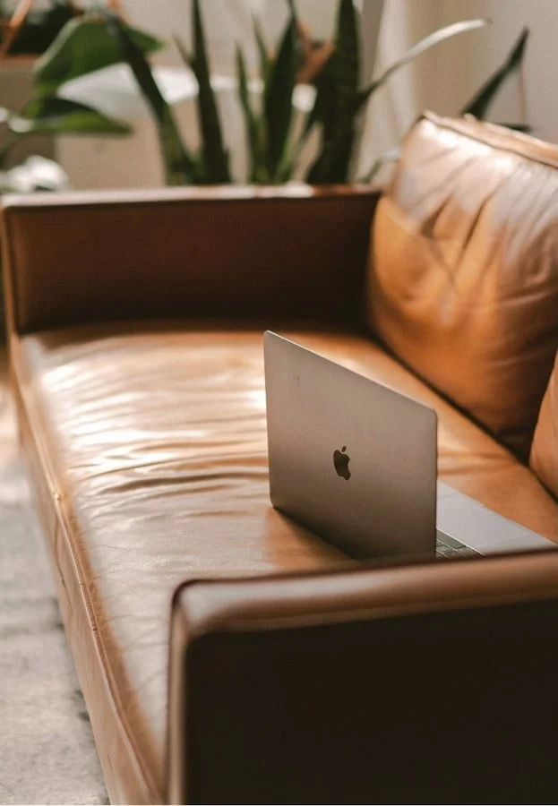 Laptop resting on a couch in the therapy office at Adaptive Resolutions Counseling in Brea, California.