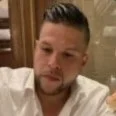 Man with short hair wearing a white shirt