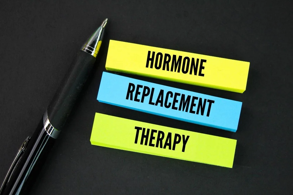 Hormone Replacement Therapy (HRT) concept shown with colorful sticky notes and a pen on a black background, symbolizing treatment options for menopause symptom relief, estrogen therapy, and bioidentical hormones.
