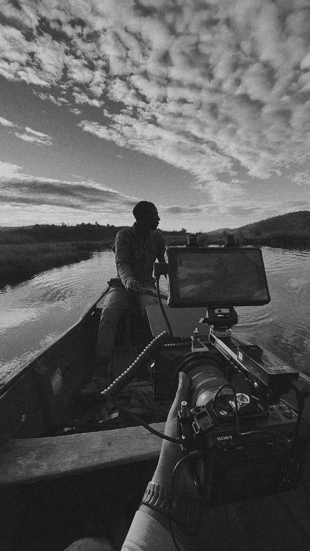 James Rooney filming someone in the boat