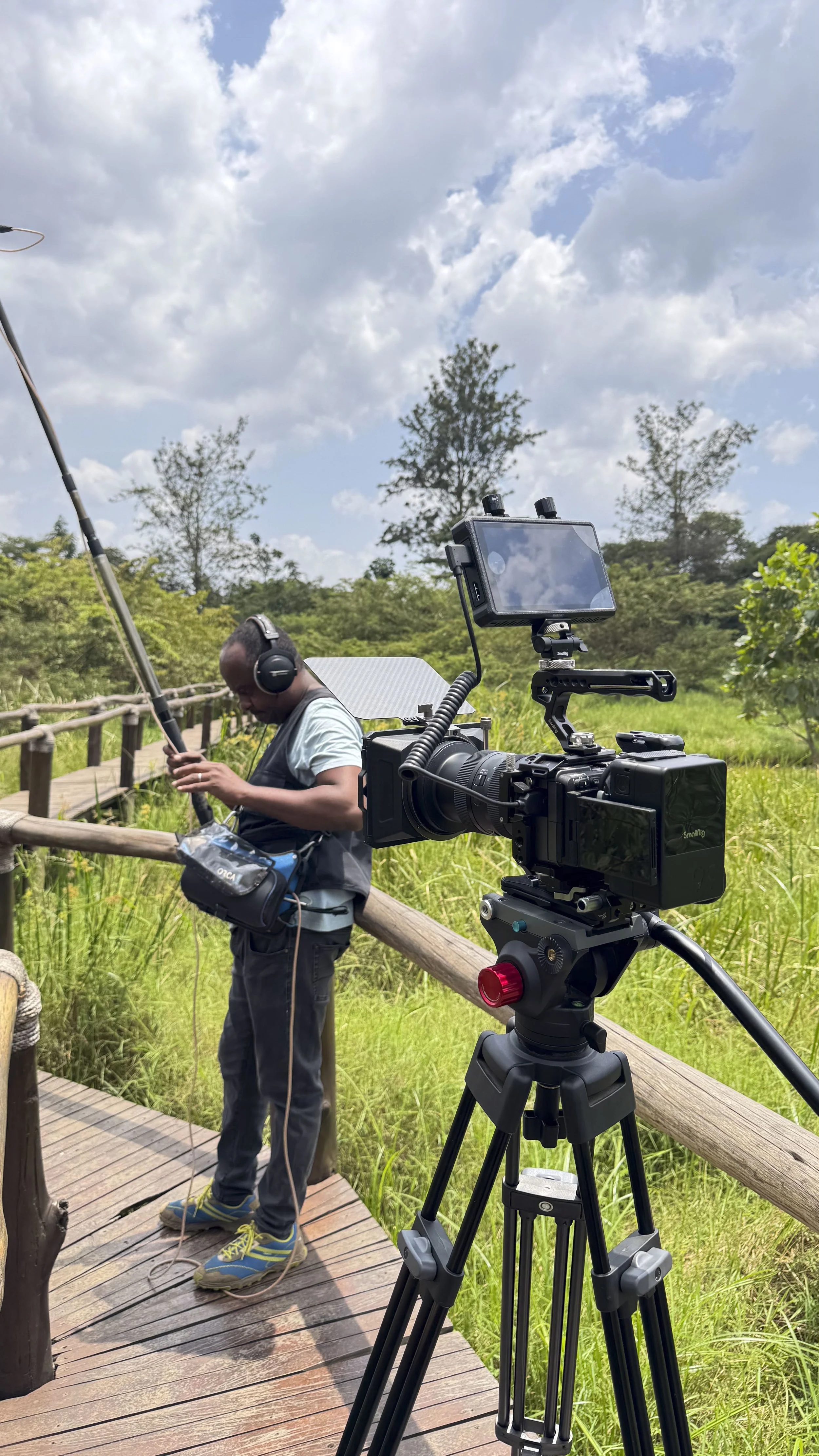 Sound person testing his kit, prepping an interview shoot at Umusambi Village