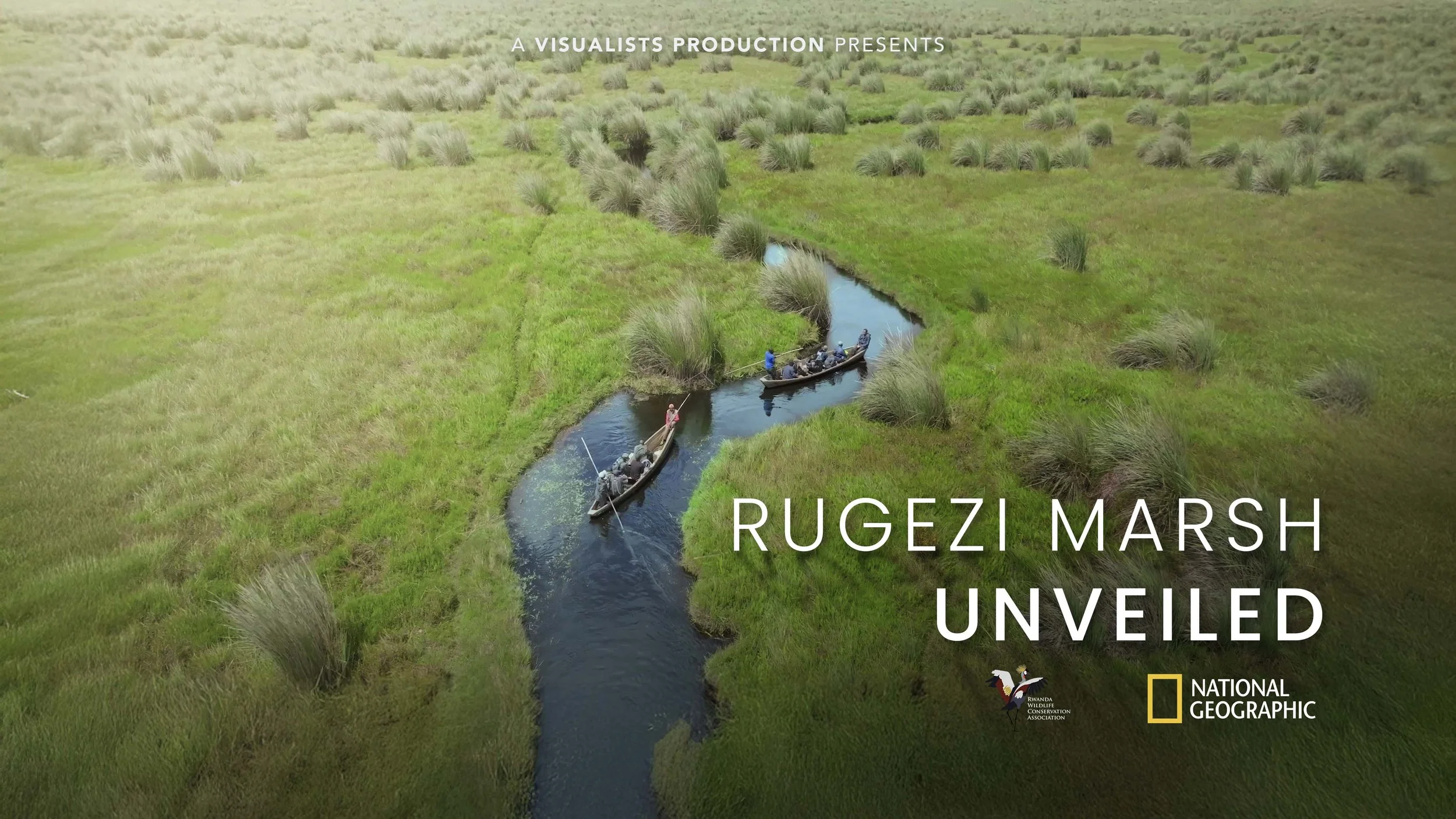 Aerial view of Rugezi Marsh with grassy banks and a narrow waterway, two boats with people fishing or navigating, surrounded by green marshland and tufts of tall grass, National Geographic branding.