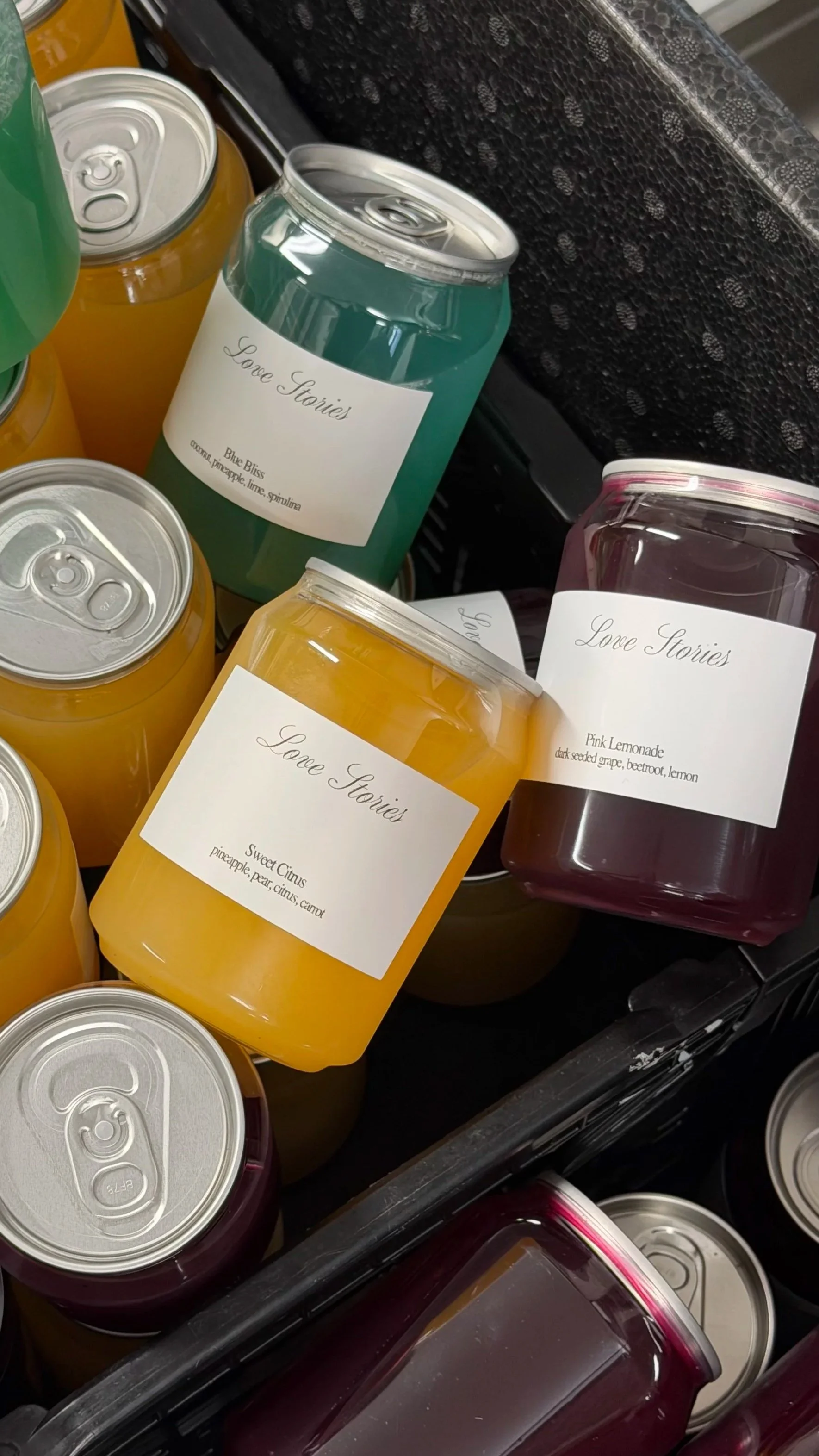 close up of individually branded juices in cans