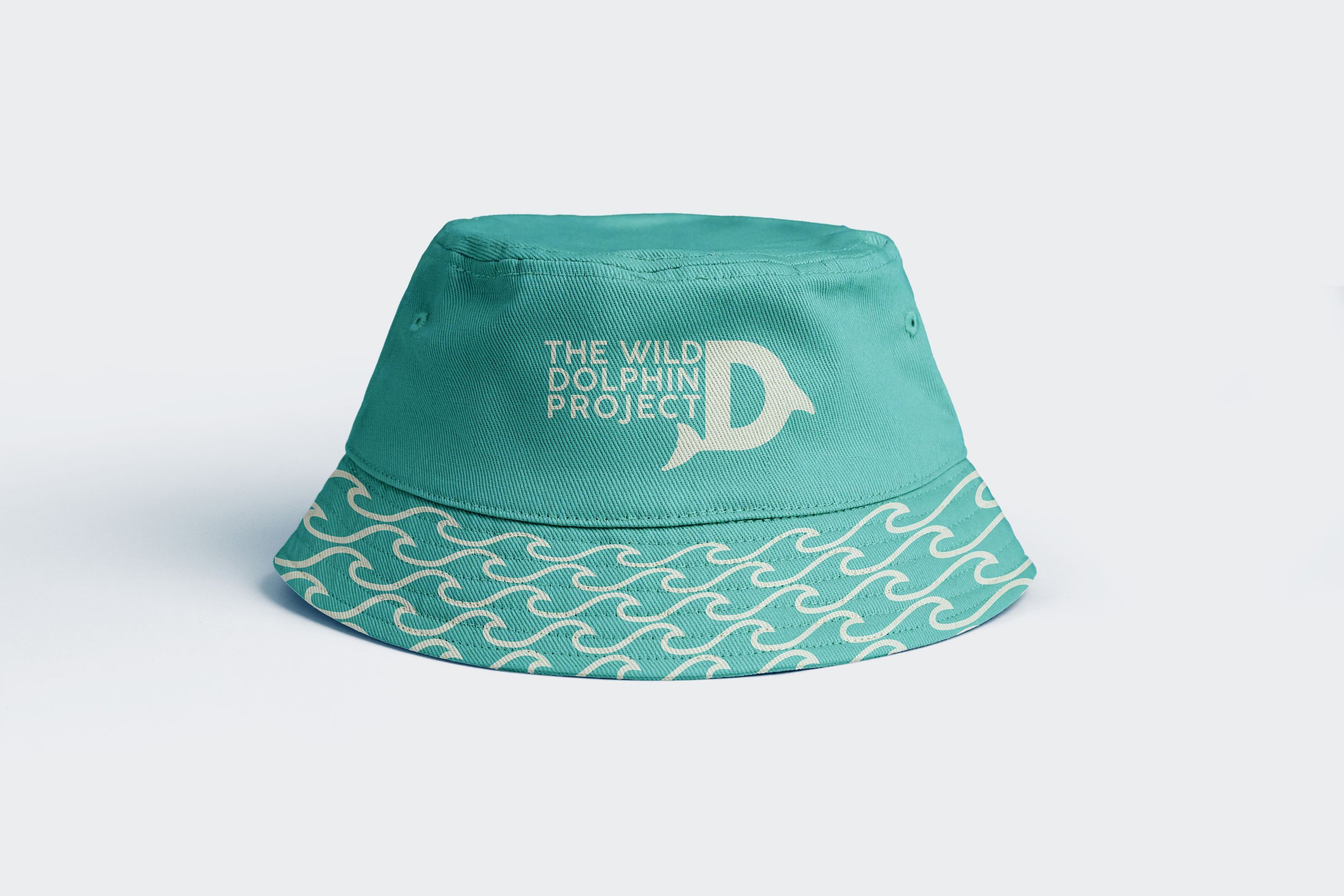 Teal bucket hat featuring "The Wild Dolphin Project" logo and wave pattern design.