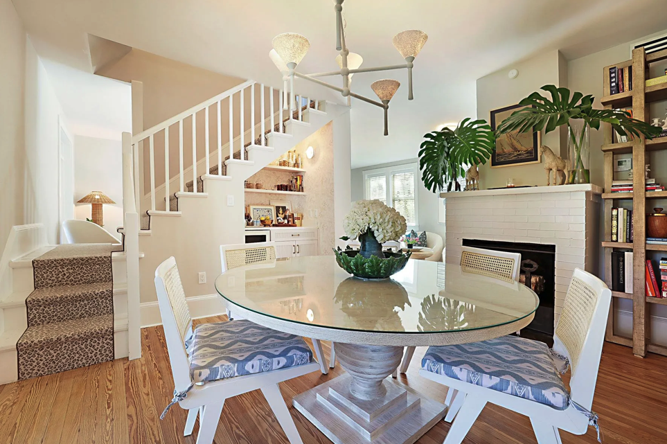 coastal-dining-room-white-fireplace-open-shelving.png