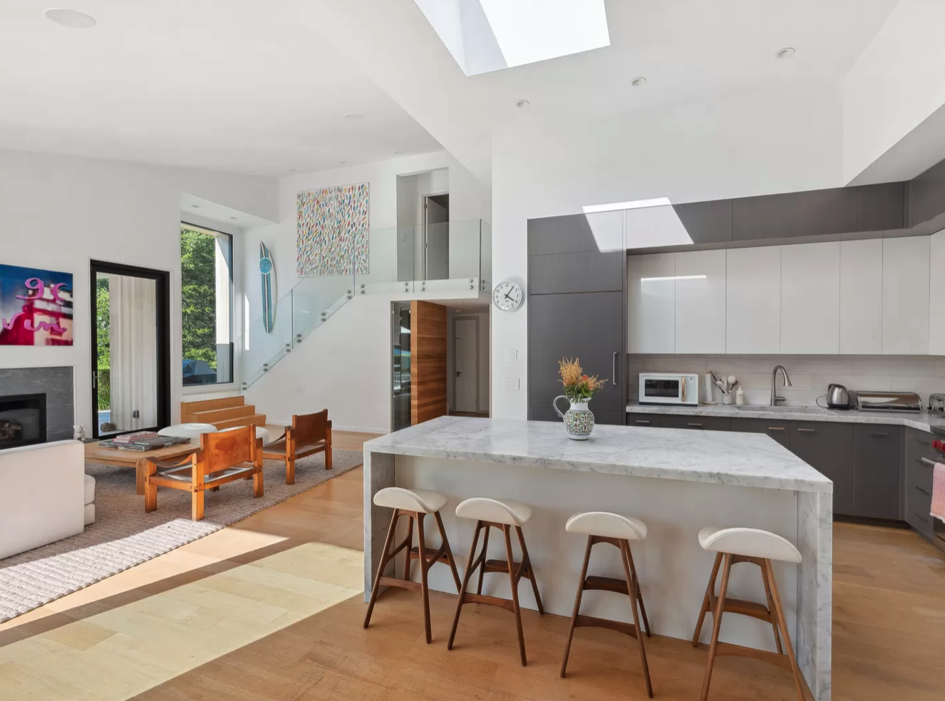 modern-open-concept-kitchen-living-room-skylight-staircase.png