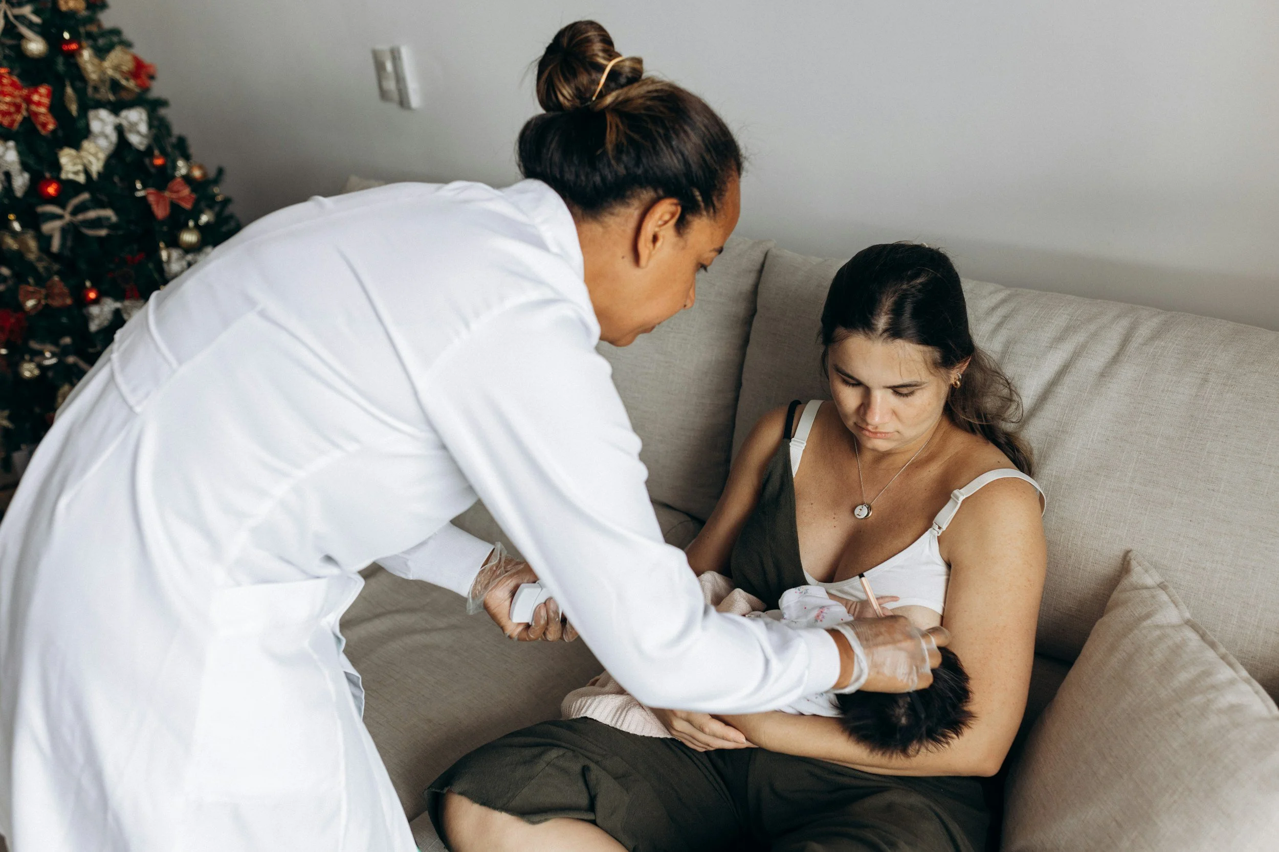 postpartum doula aiding new mother