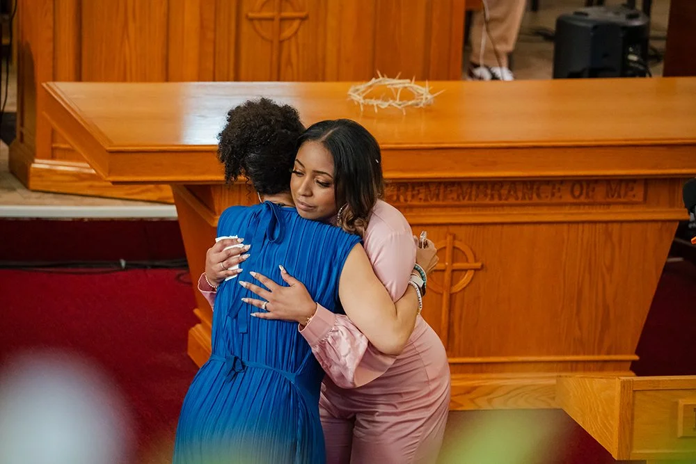 Shamyra Lavigne of Rise St. James embracing the MC Antonique Smith.