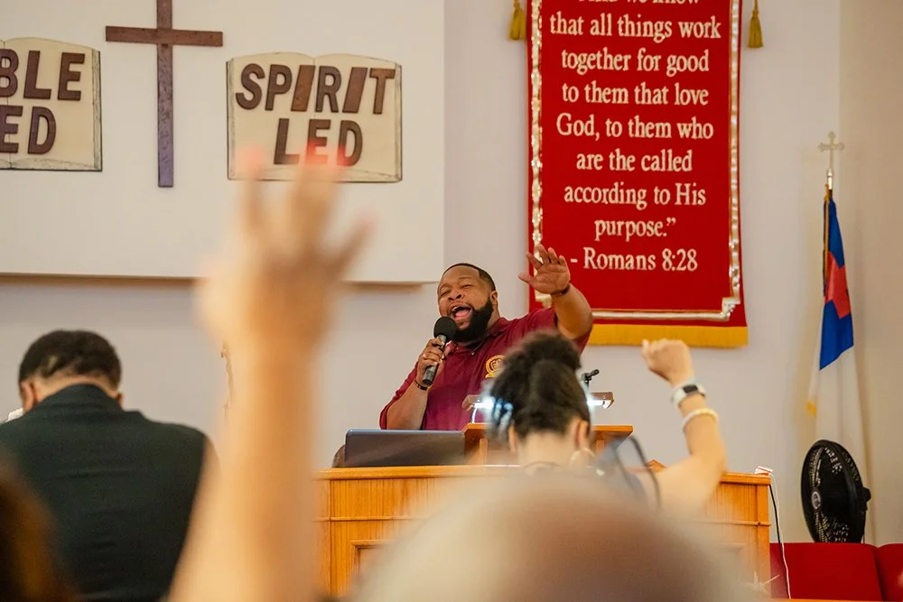 Dr. Reverend Patrick Thompson of Pleasant Zion Missionary Baptist Church opening the program with scripture and prayer.