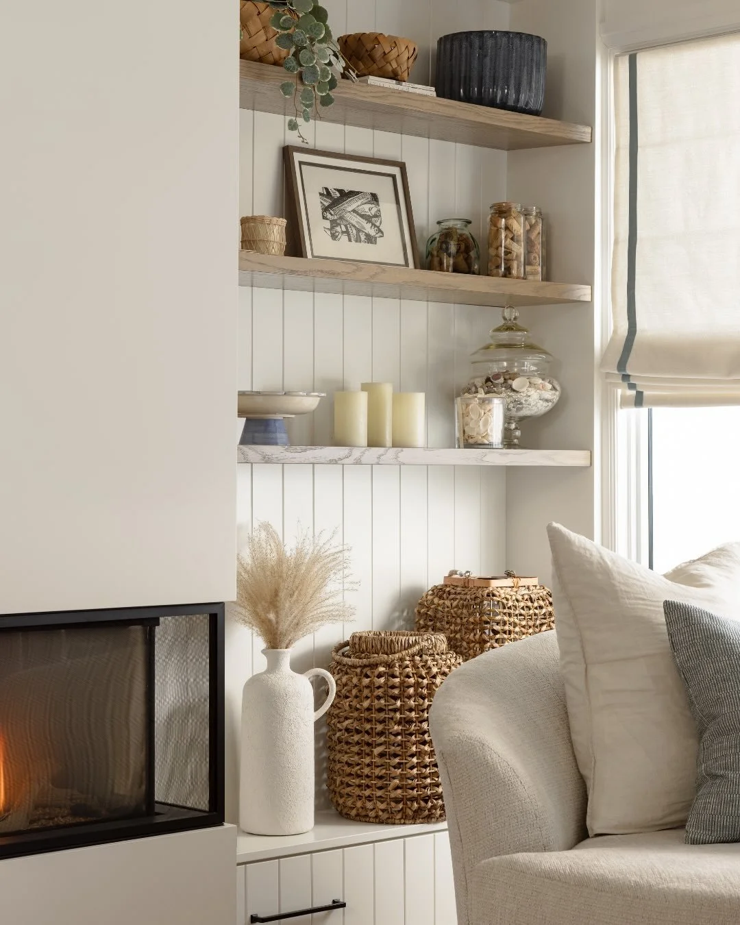 Somewhere between a Swiss chalet and a beach house, right on the edge of Ontario&rsquo;s Georgian Bay.⁠
⁠
Step inside our Wasaga Beach house living room: airy and inviting, featuring farmhouse-style oak floating shelves and cleverly disguised storage